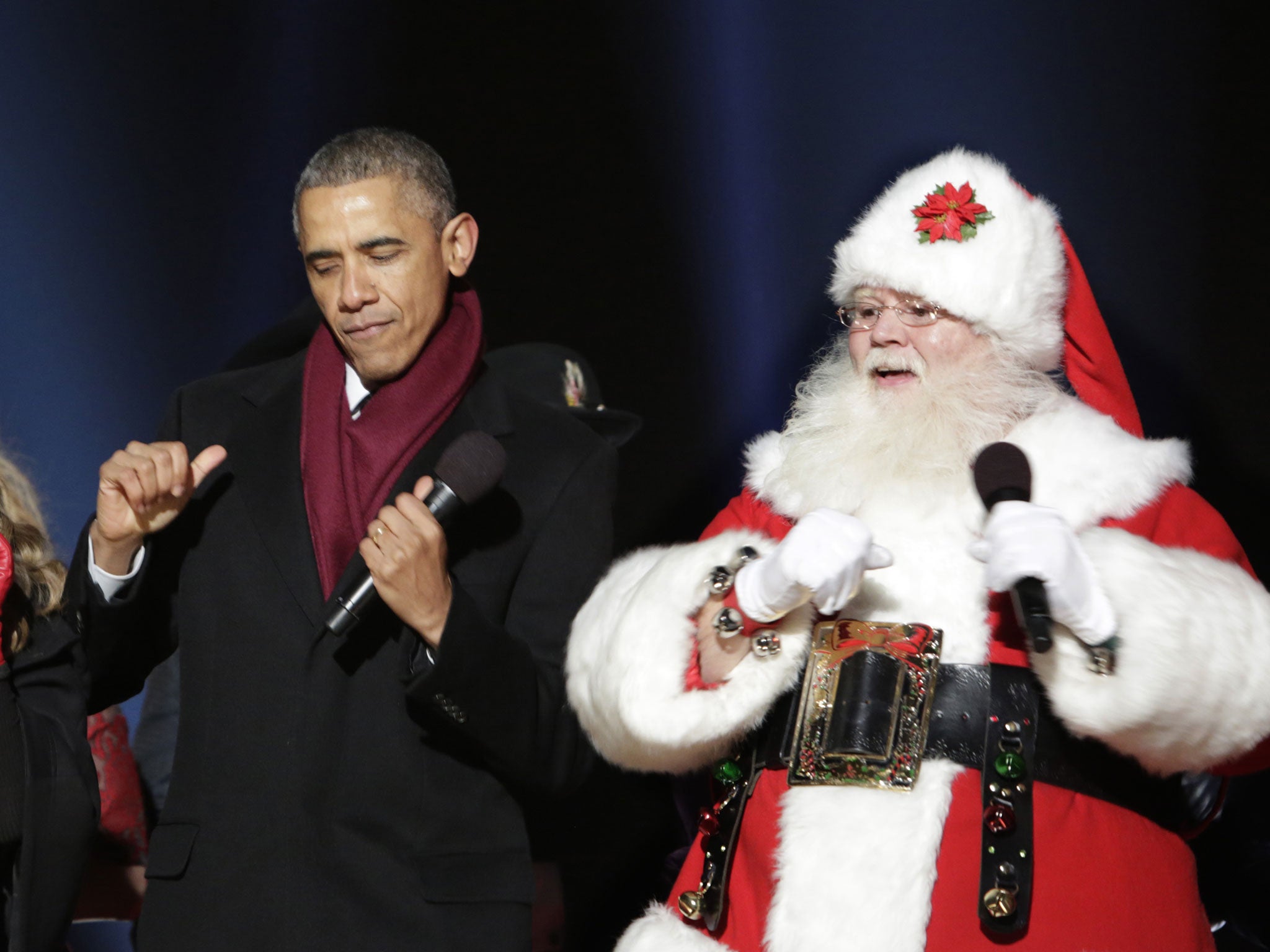 Barrack Obama dances alongside Father Christmas at the lighting of the US National Christmas tree