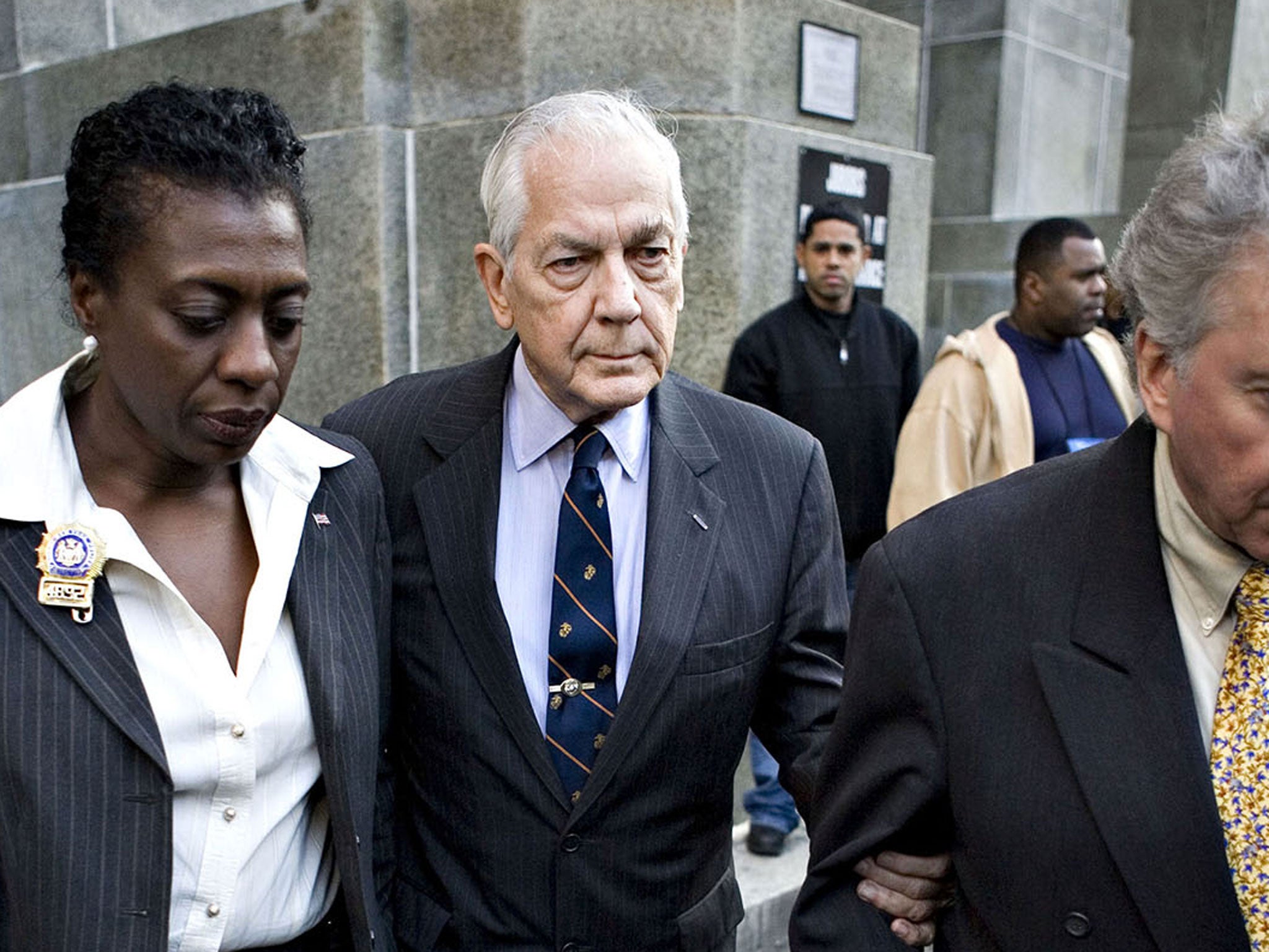 Anthony Marshall (centre) is escorted out of Manhattan District Attorney Robert Morgenthau's office in New York