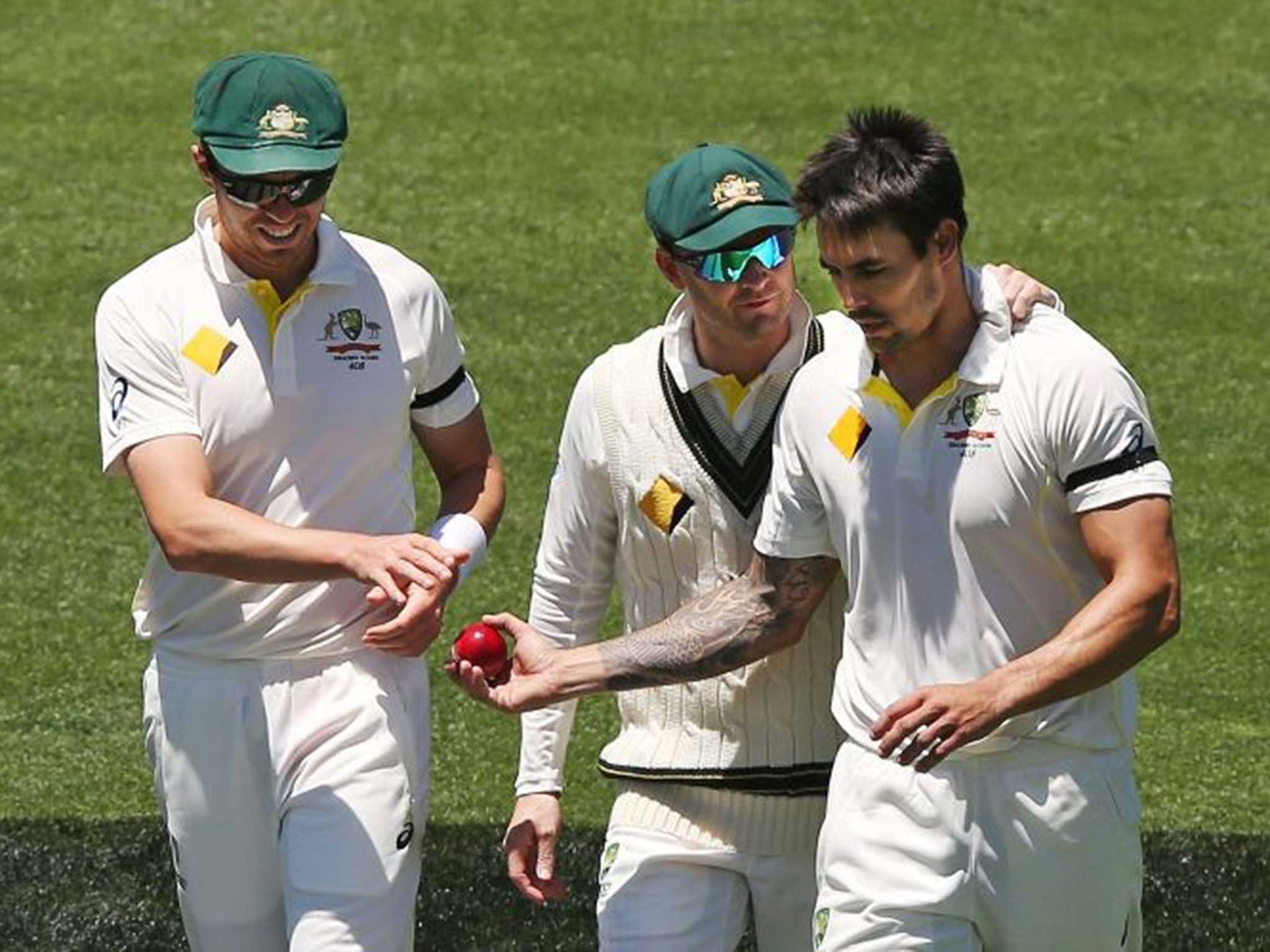 Michael Clarke talks to Mitchell Johnson (right) after the bowler struck Virat Kohli on the helmet with a bouncer