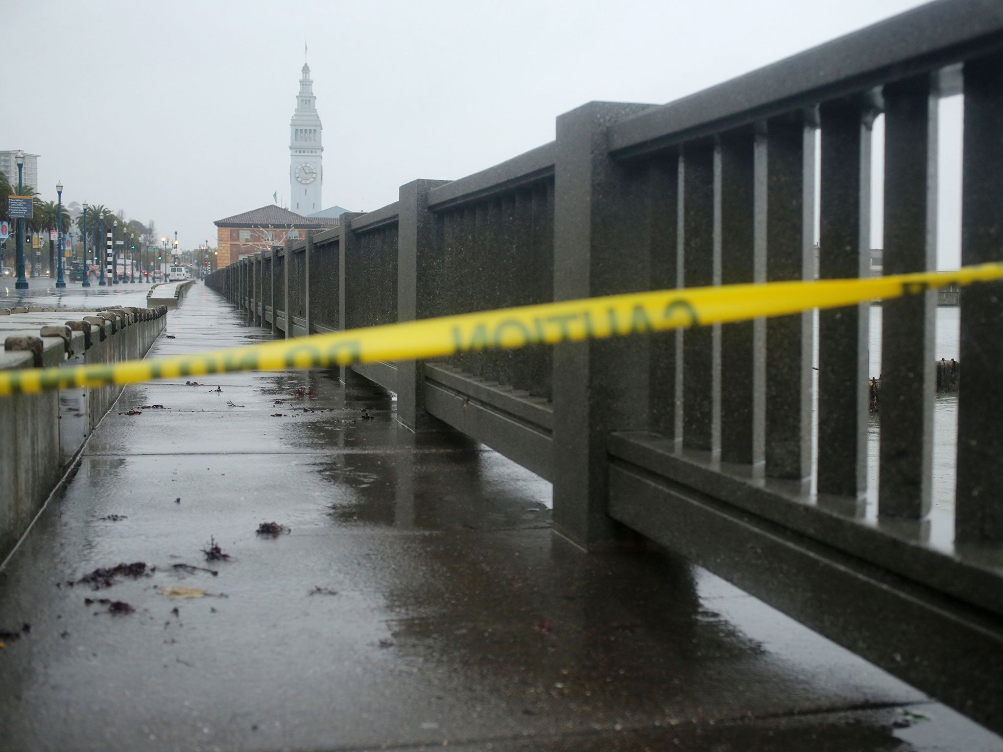 Police tape is pictured on the Embarcadero, which was closed due to the weather, in San Francisco