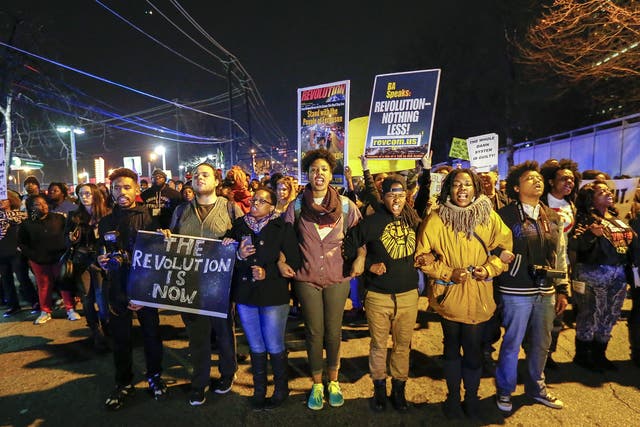 Protesters block Spring Street during a protest against the decision of a grand jury not to indict a police officer involved in the death of Eric Garner in Atlanta, Georgia USA