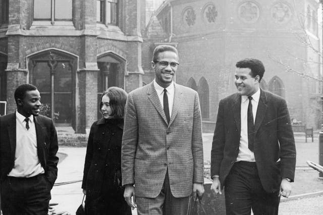 Black Nationalist leader and Nation of Islam spokesman Malcolm X in Oxford with Eric Abrahams, right, the Student Union president, before addressing university students on the subject of extremism in1964.  (Photo by Keystone/Hulton Archive/Getty Images)