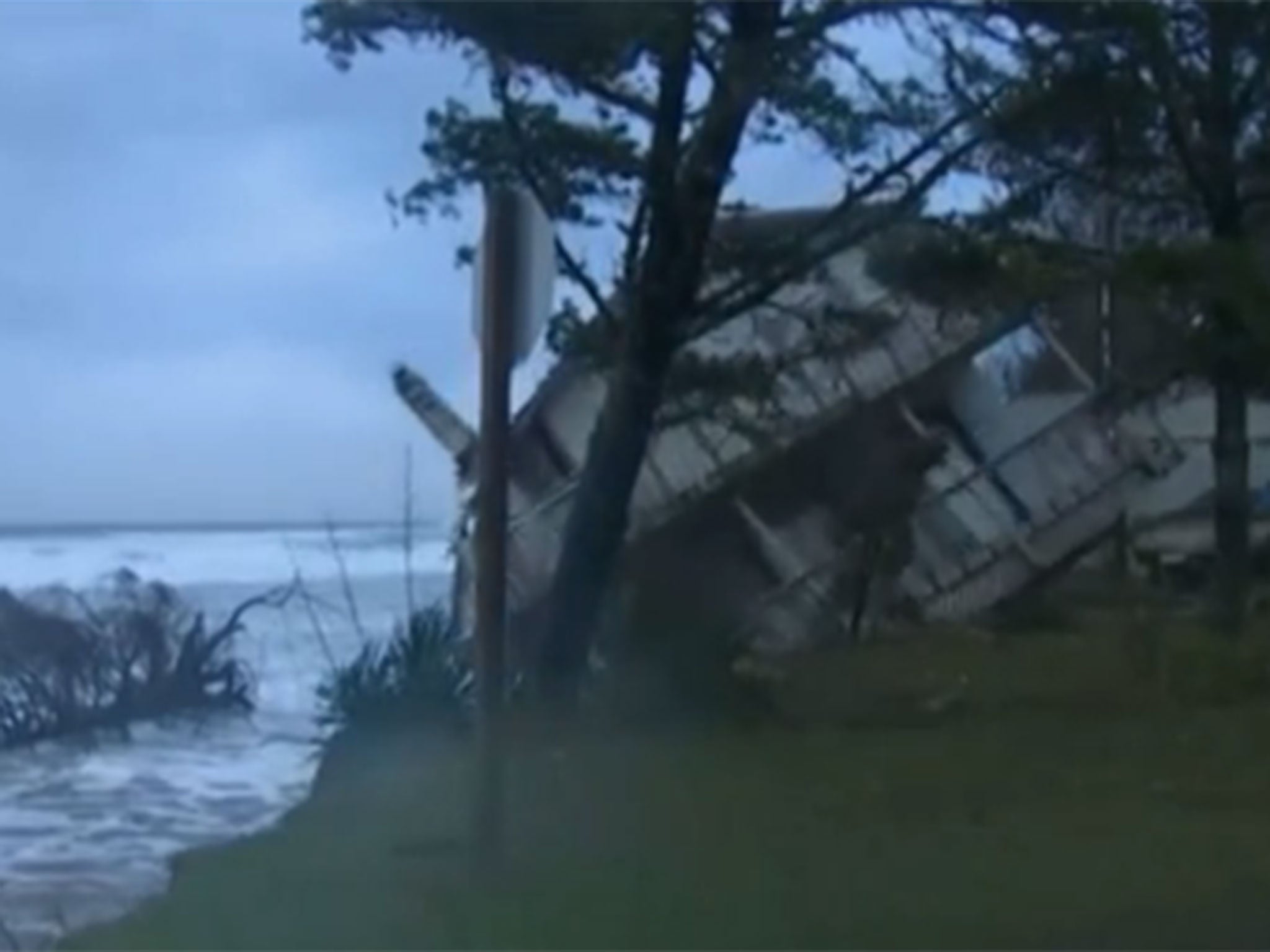 House slides into the sea as western US coast battered by storms.