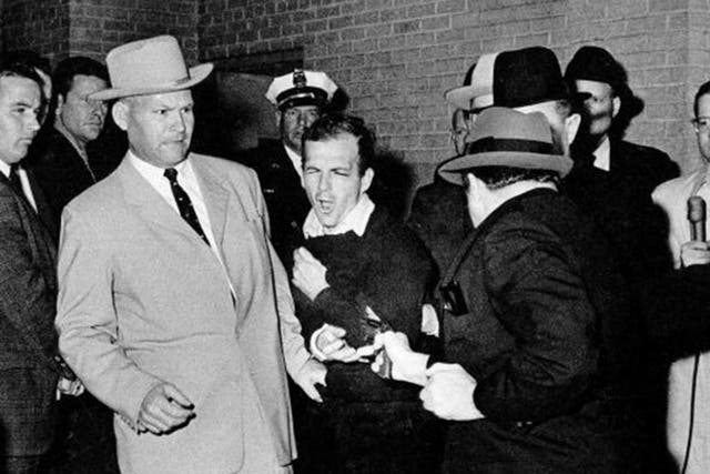 Jack Ruby shoots Lee Harvey Oswald in the basement of the Dallas police headquarters