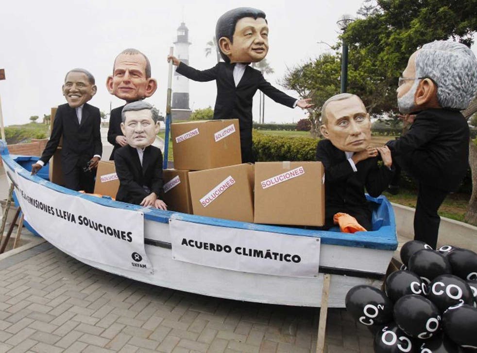 Activists wearing masks depicting US President Barack Obama, Australia’s Prime Minister Tony Abbott, and Russia’s President Vladimir Putin among others
