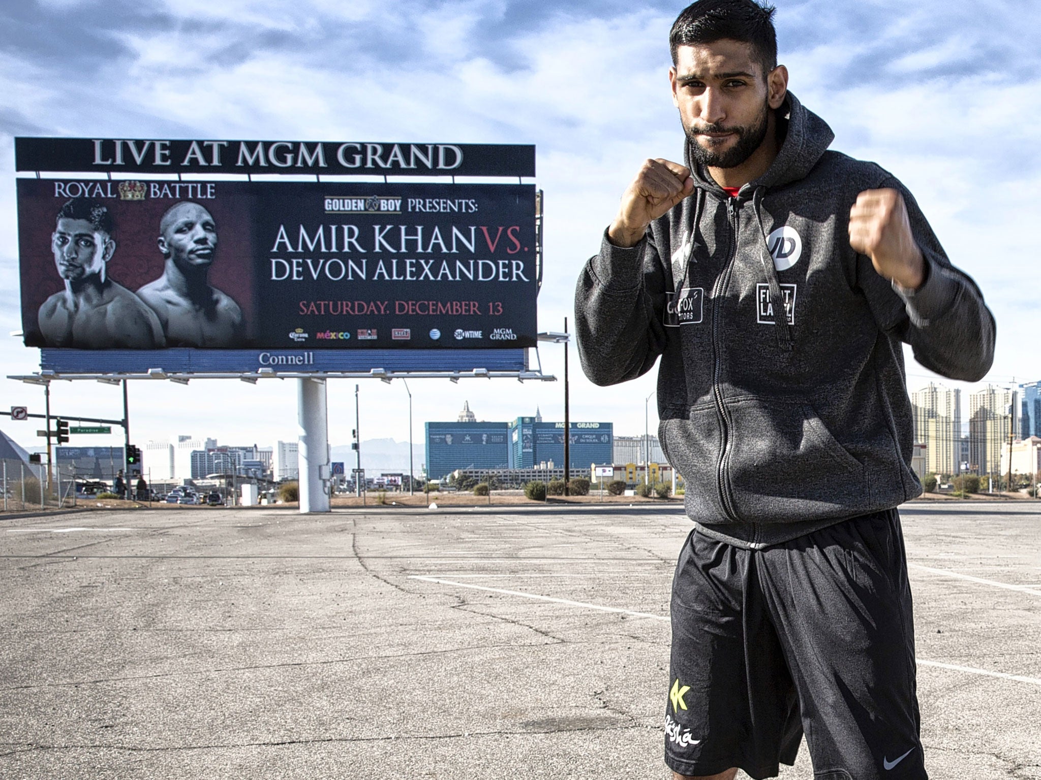 Amir Khan in front of a poster advertising his fight