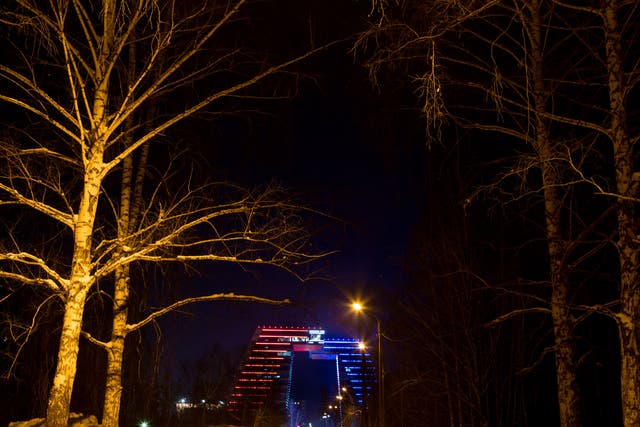 The main building of Akadempark lit up at night in the red, white and blue of the Russian tricolor. The 13-storey buildings tower over everything else in Akademgorodok. The top floor, accessible via a transparent skybridge, is a co-working space for tech entrepreneurs