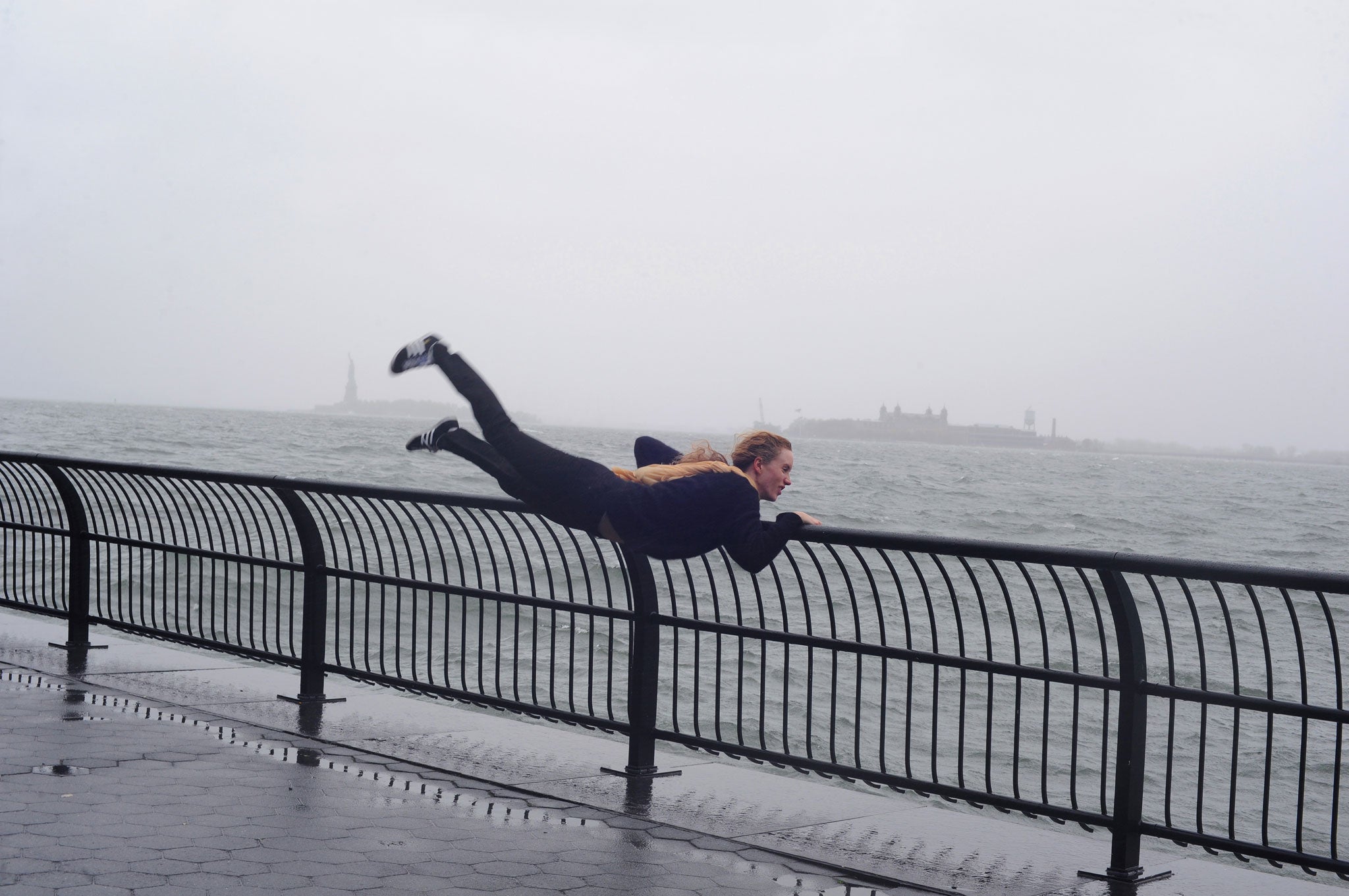 Cervera photographed a woman hanging off a railing in New York during Hurricane Sandy