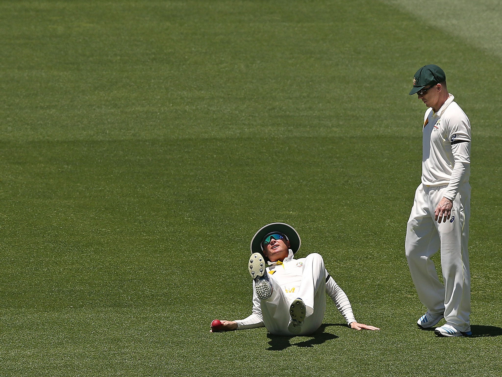 Michael Clarke falls to the ground after suffering a hamstring injury