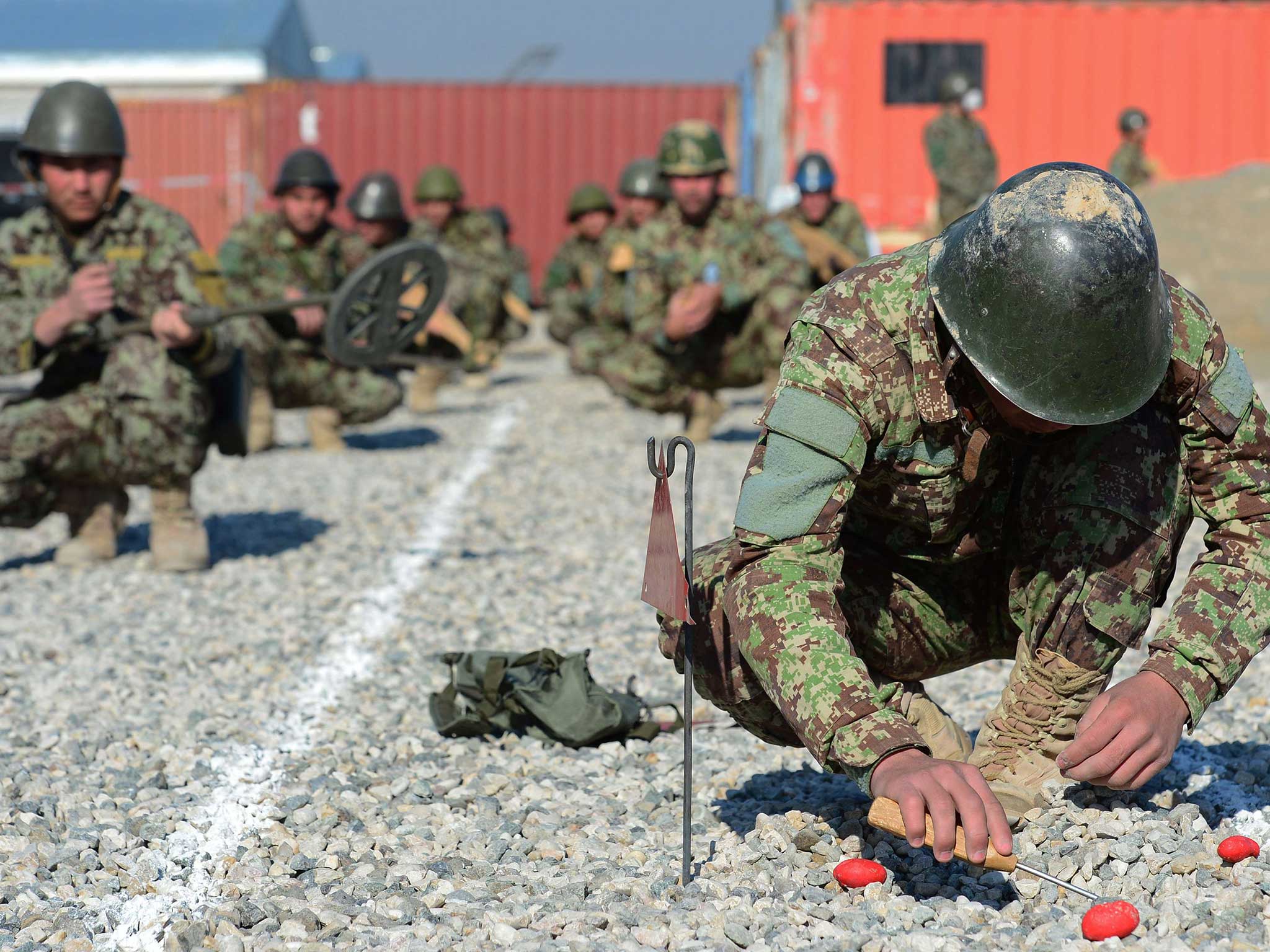 A member of the Afghan National Army practises detonating a mine