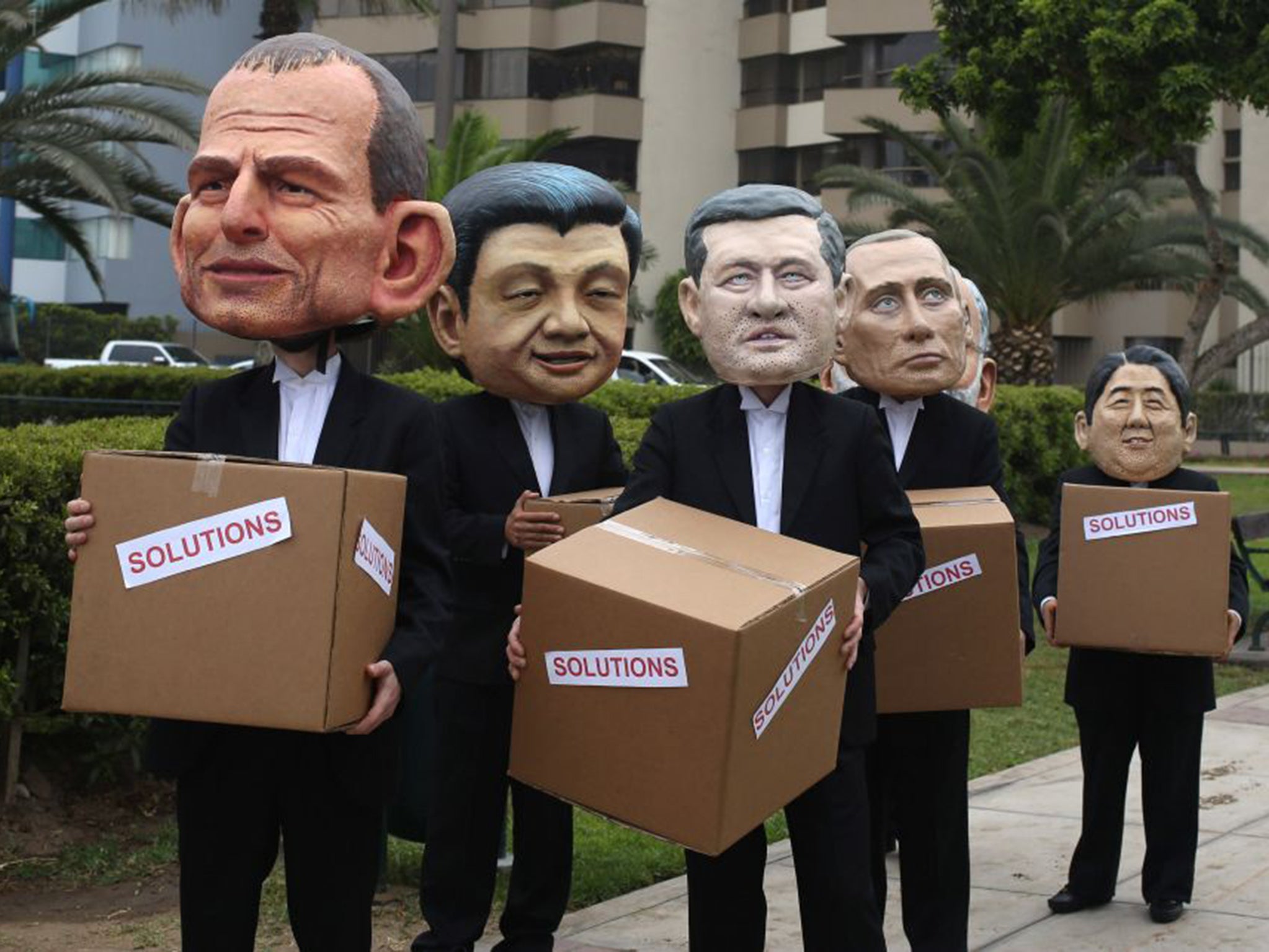 Face off: Activists wearing masks of world leaders protest at the Lima talks