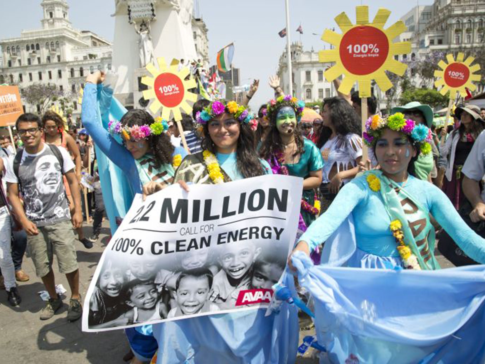 Protestors at the People's Climate March in Lima, Peru calling for the ministers at the UN Climate talks to agree to a global shift to 100 per cent clean energy by 2050