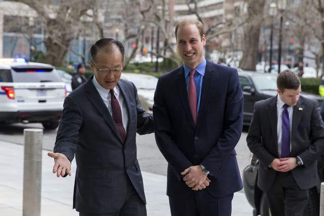 Prince William is greeted by World Bank President Jim Yong Kim before speaking during an International Corruption Hunters Alliance event at the World Bank in Washington