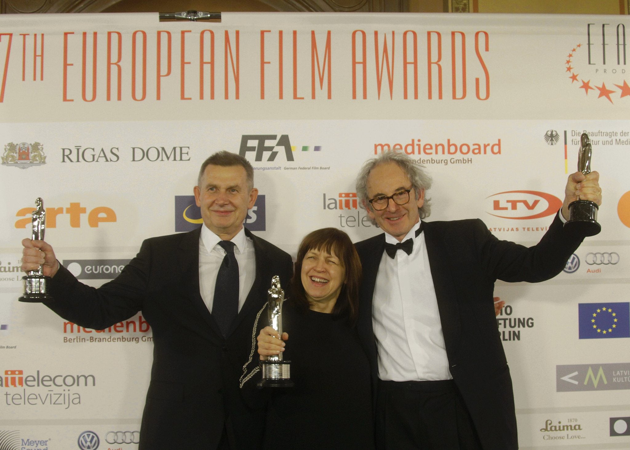 Producers Eric Abraham (R), Piotr DziÊciol and Ewa Puszczynska (C) pose with European Film Awards for r Best European Film 'Ida'
