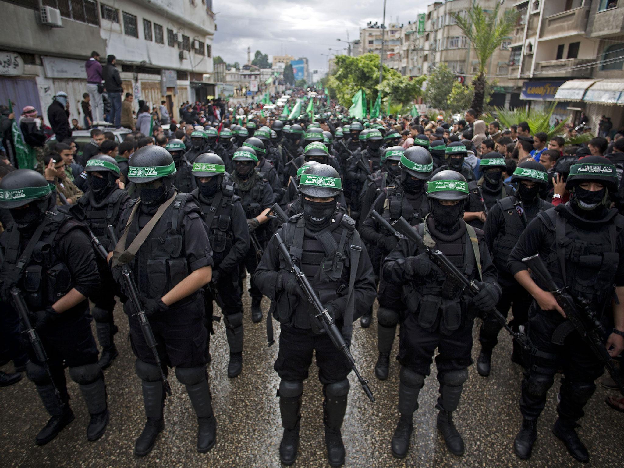 Hamas gunmen display their military skills during a rally to commemorate the 27th anniversary of the militant group