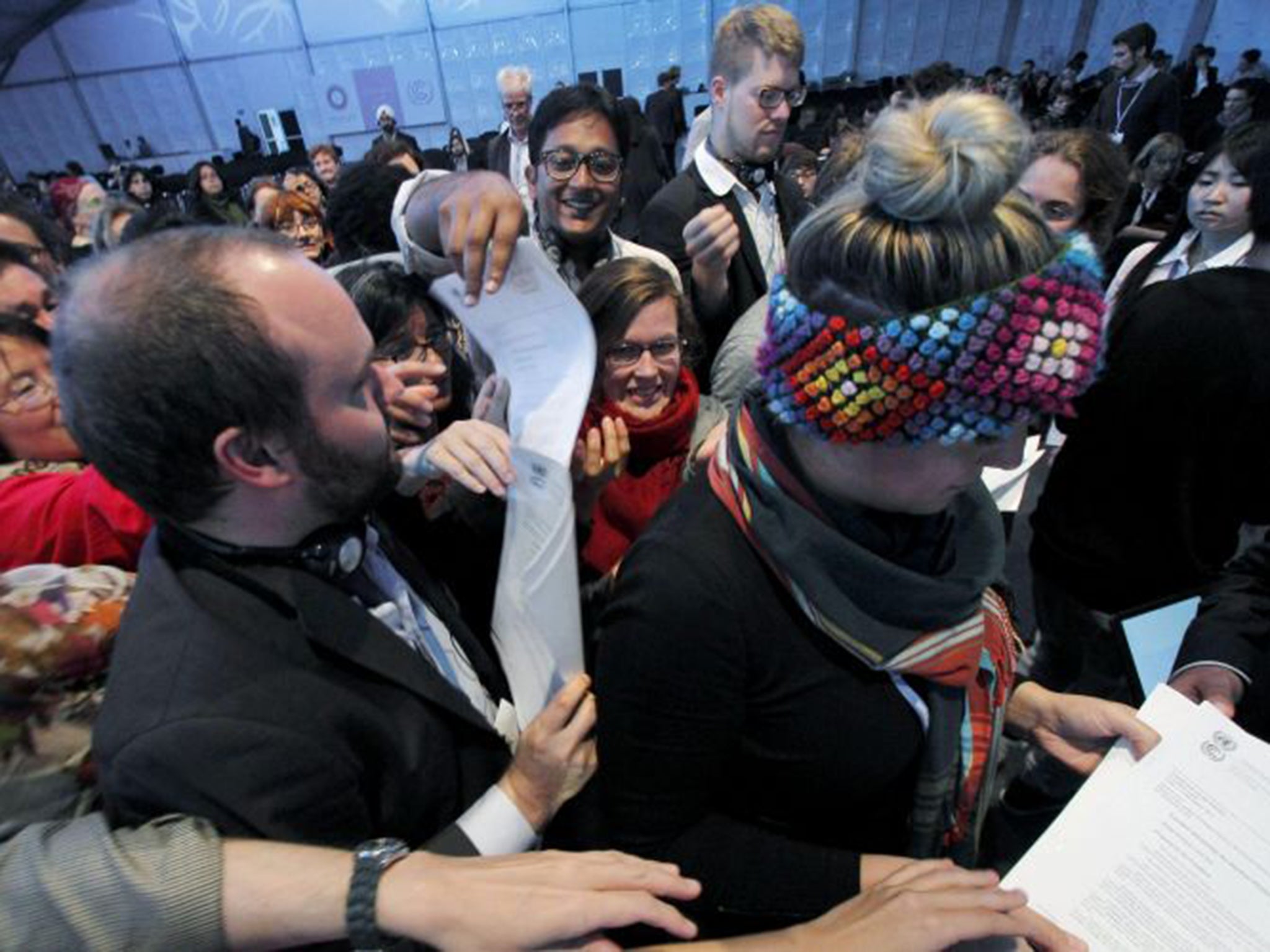 Delegates receive copies of the deal agreed at the UN climate change talks in Lima on Sunday