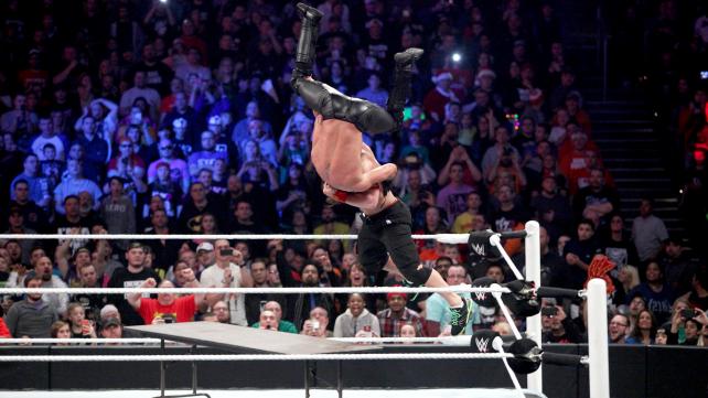 John Cena AA's Seth Rollins through a table