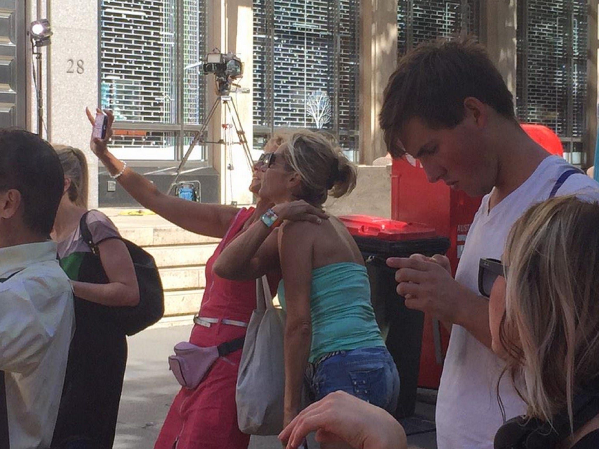 Two women take a selfie photo close to the café where around 15 people were taken hostage