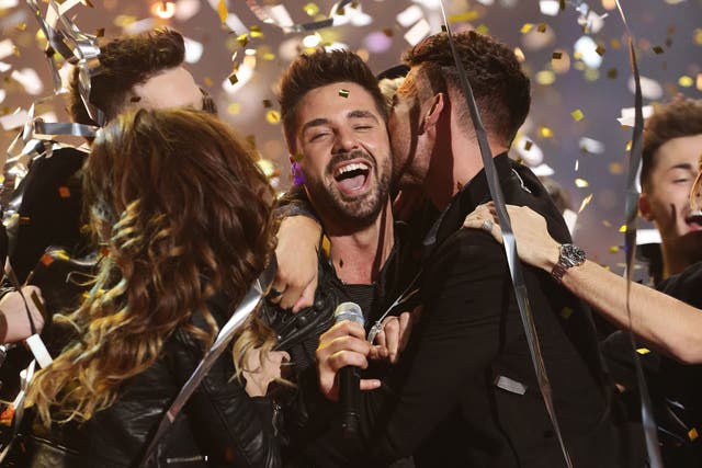 Ben Haenow is mobbed by his fellow X Factor contestants after winning the 2014 show