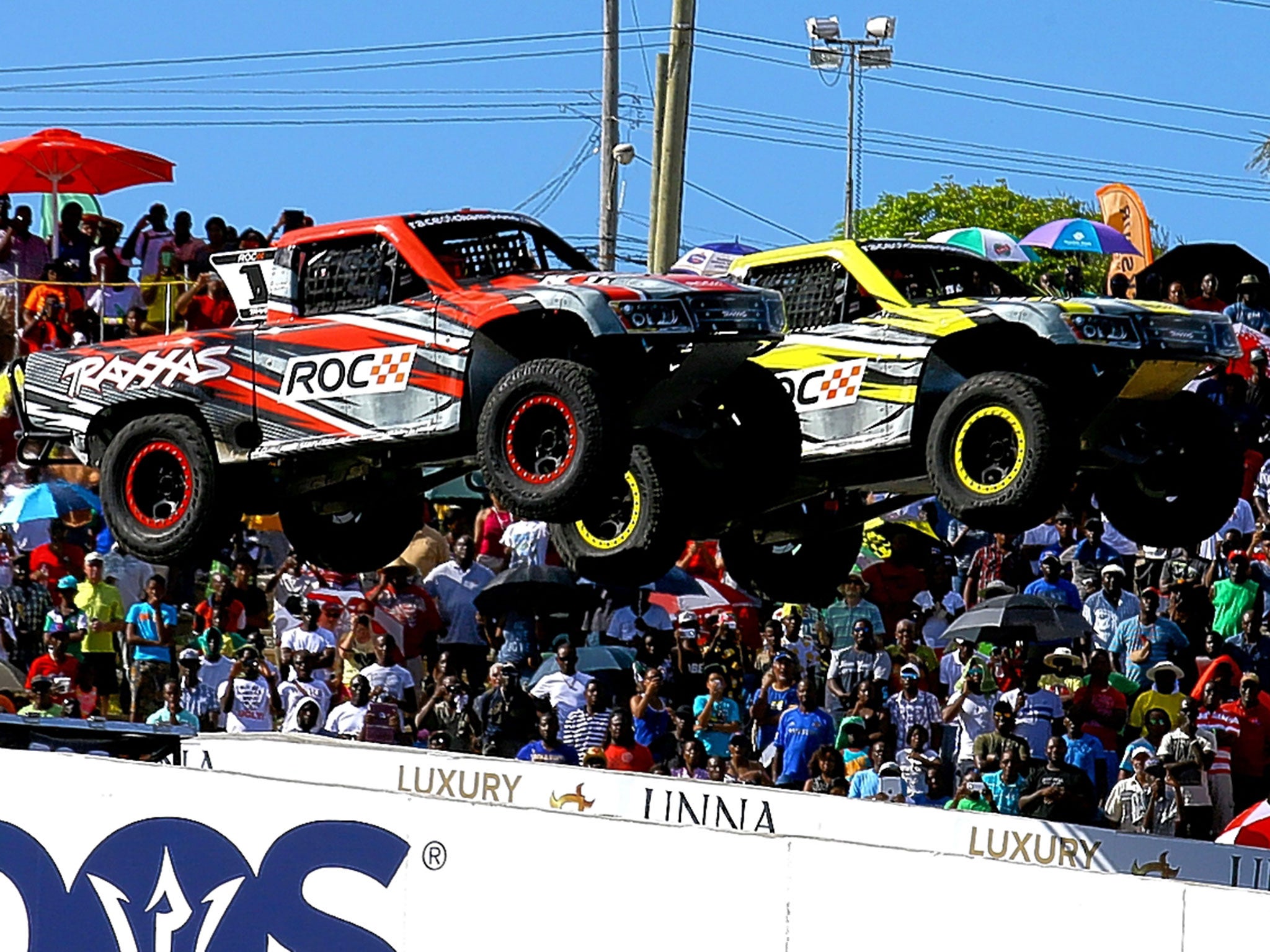 A pair of supertrucks take to the air at the Race of Champions in Barbados