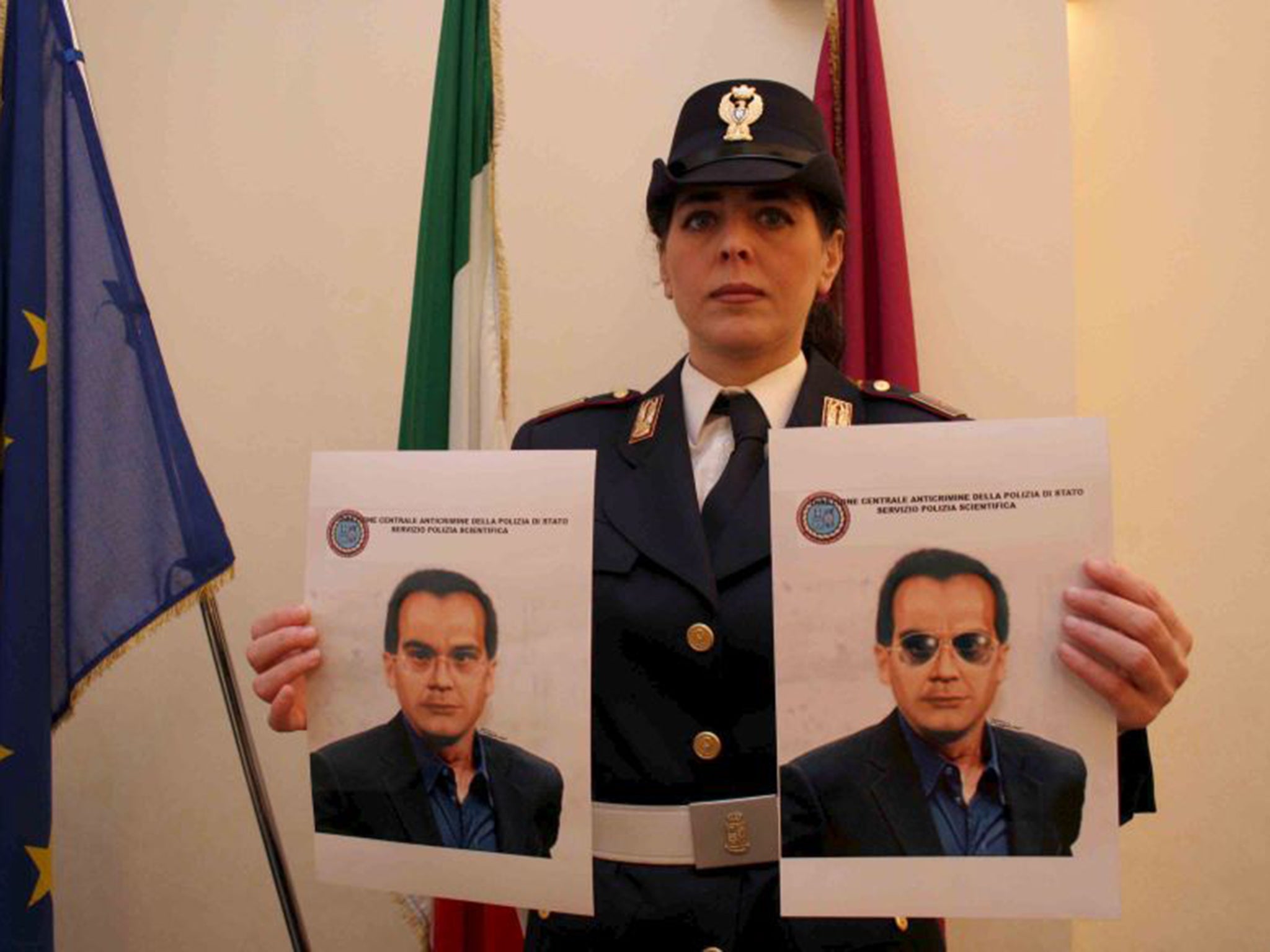 A police officer shows two pictures of Matteo Messina Denaro, nicknamed Diabolik, during a press conference in Palermo, Sicily (EPA)