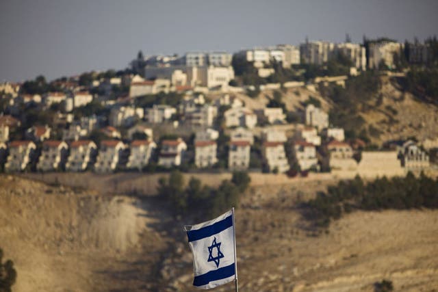 An Israeli flag flies in front of the West Bank Jewish settlement of Maaleh Adumim on the outskirts of Jerusalem in 2009 (AP)