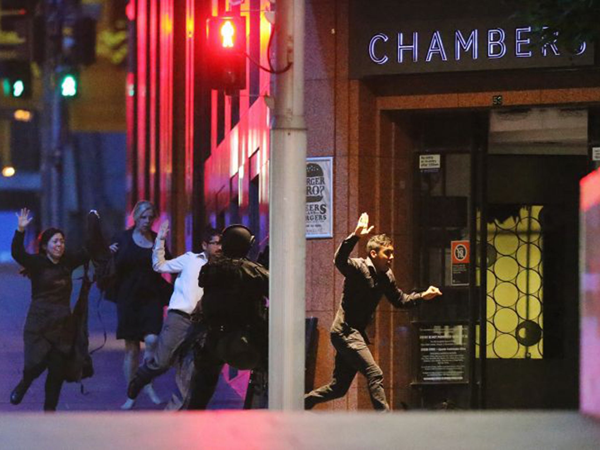 Hostages flee from the Lindt café in Martin Place yesterday after police stormed the premises to end Man Haron Monis’s 16-hour siege
