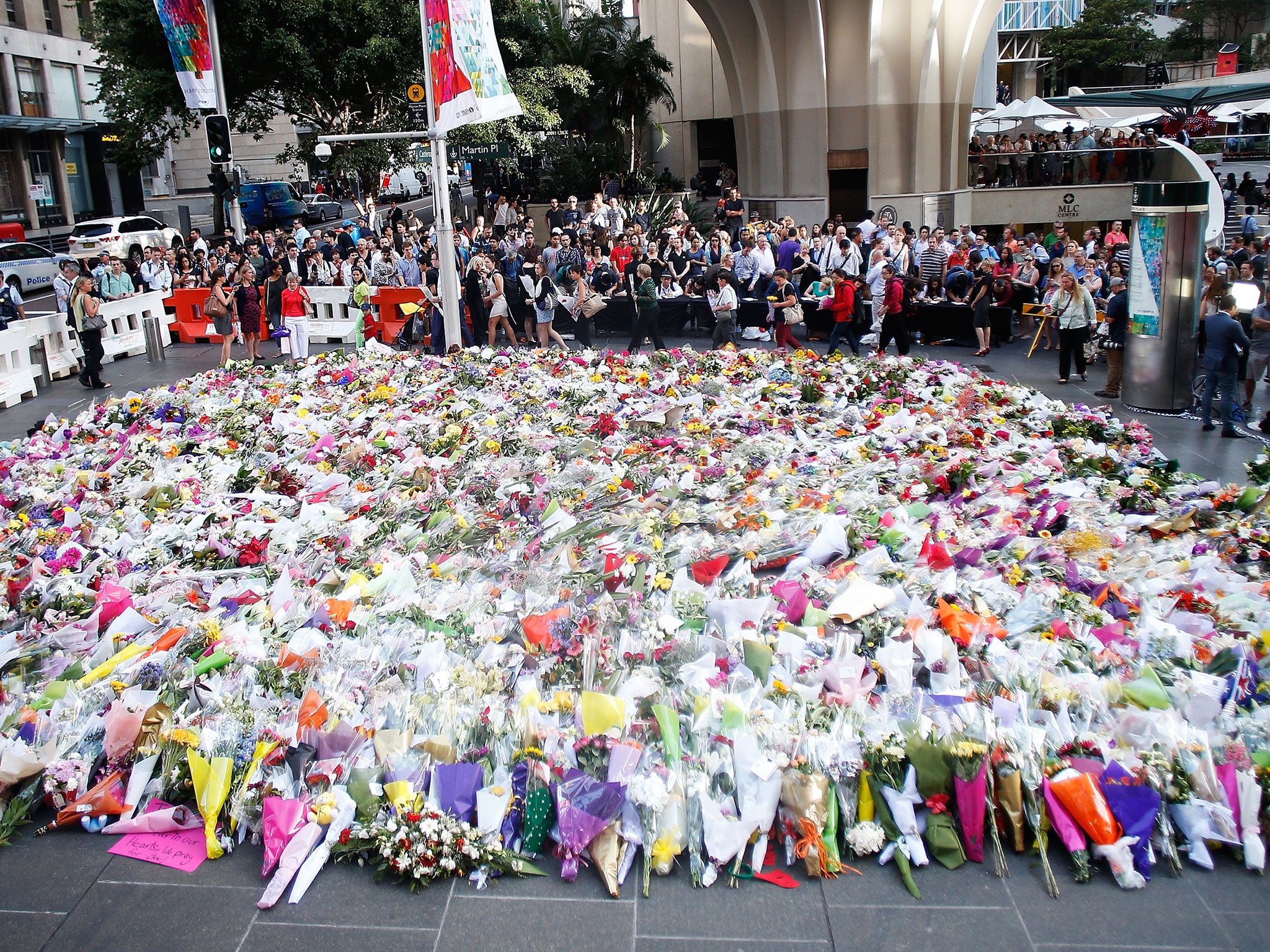 Flowers are placed by people as a mark of respect for the victims of Martin Place siege in Sydney