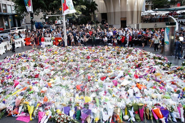 Flowers are placed by people as a mark of respect for the victims of Martin Place siege in Sydney 