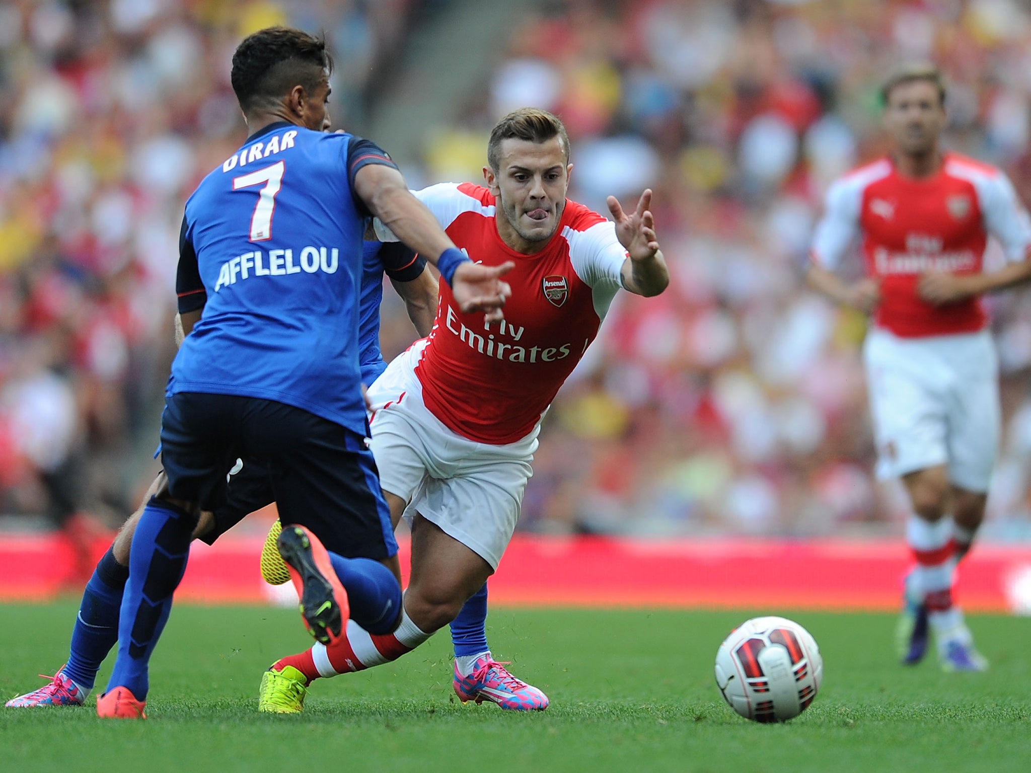 Alex Jack Wilshere of Arsenal takes on Nabil Dirar of AS Monaco during the Emirates Cup.