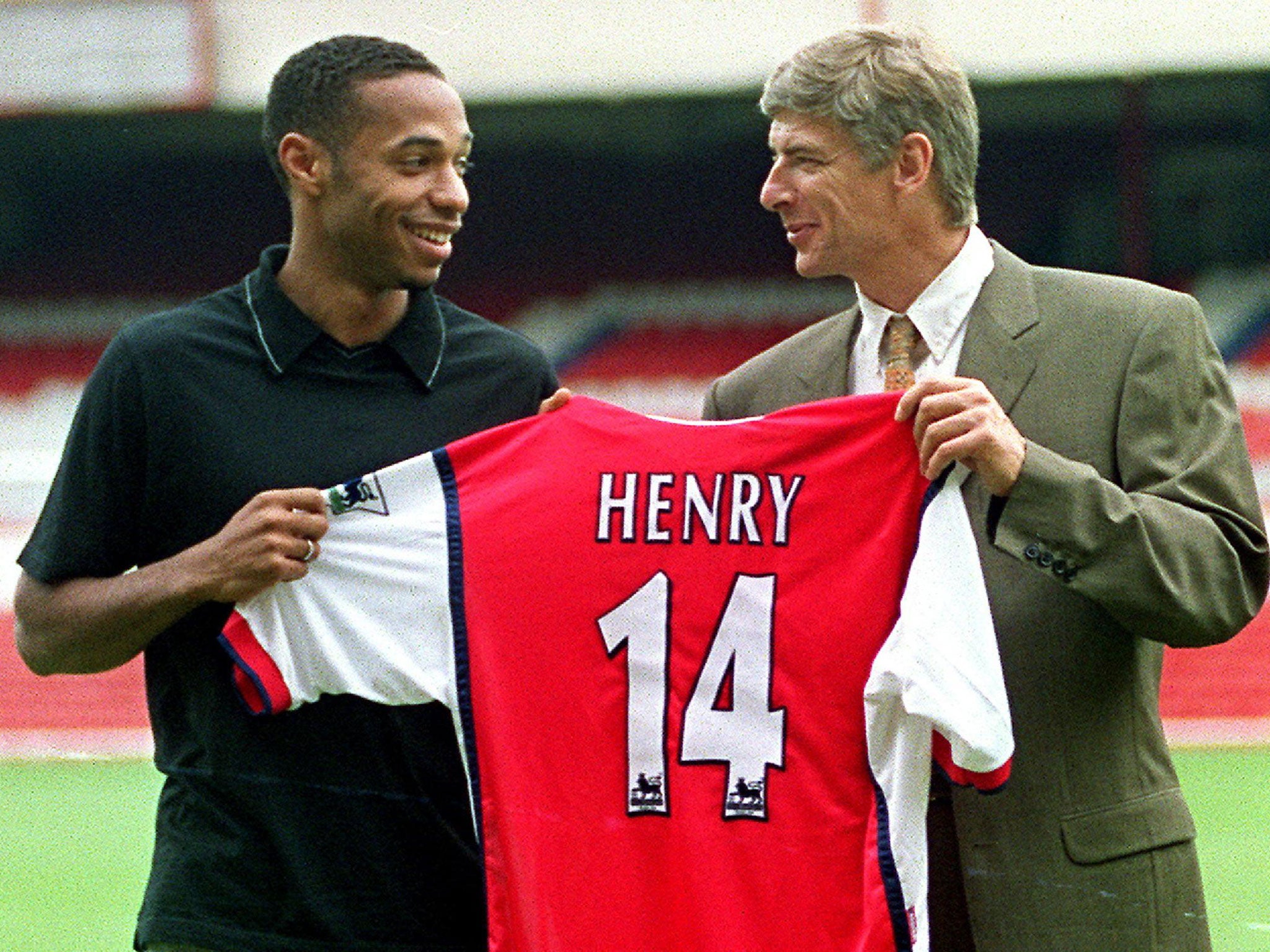 Thierry Henry is presented as an Arsenal player alongside Arsene Wenger in 1999
