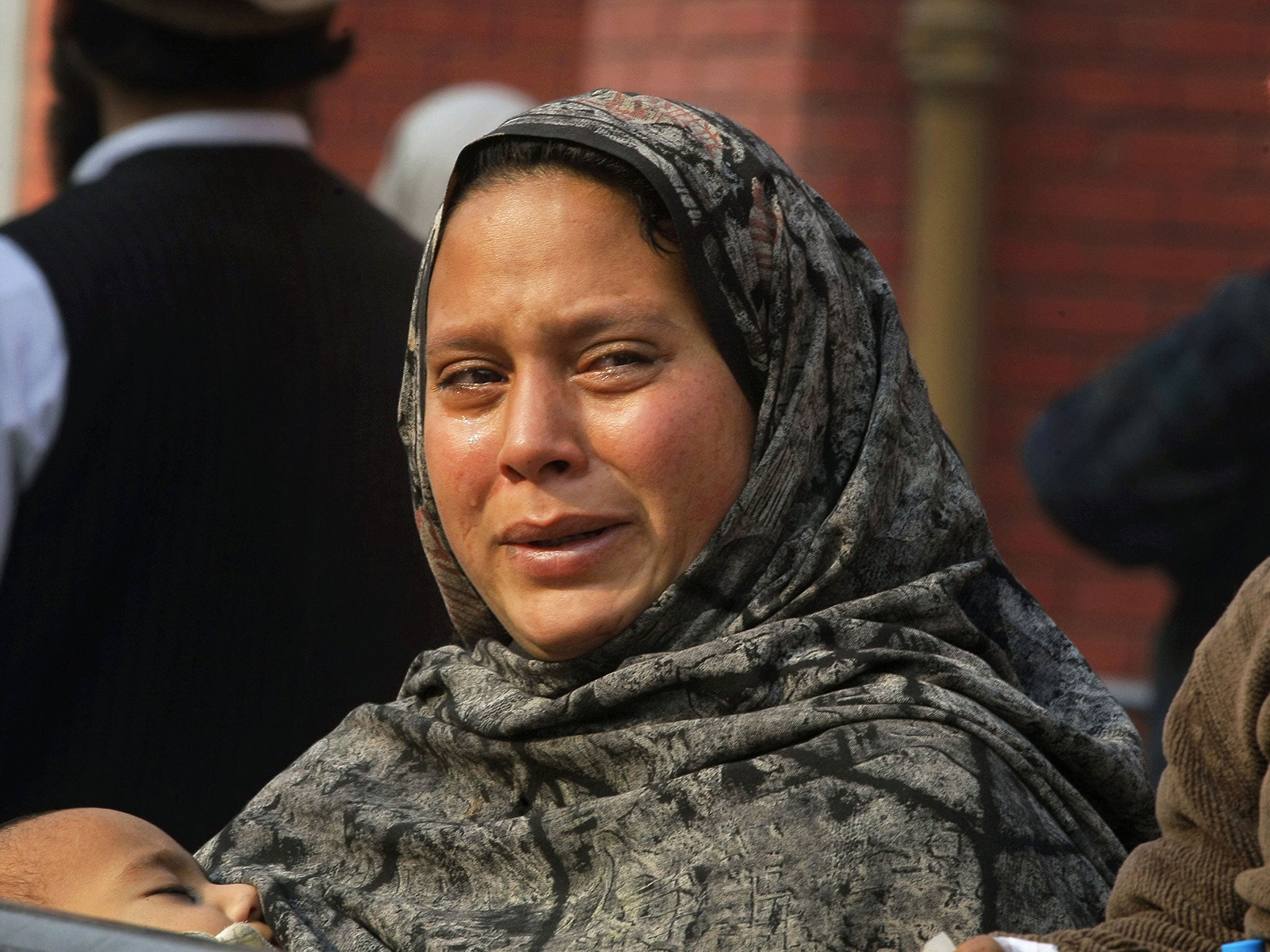 A Pakistani woman weeps as she waits at a hospital, where victims of a Taliban attack are being treated in Peshawar