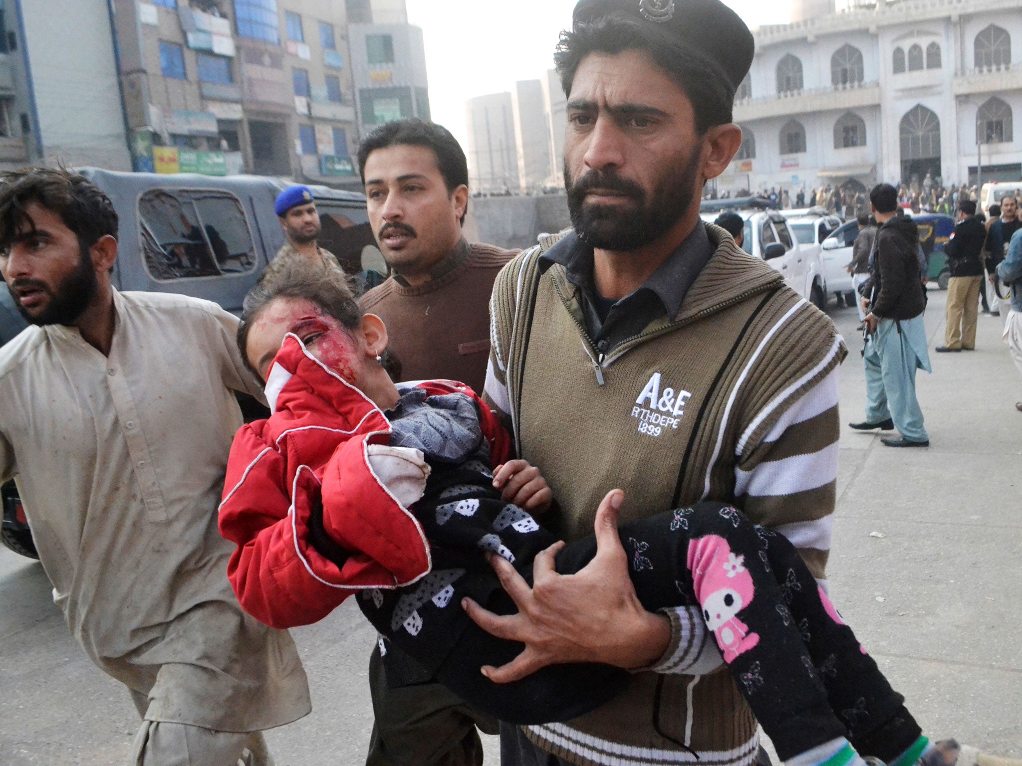 A Pakistani girl, who was injured in a Taliban attack in a school, is rushed to a hospital in Peshawar