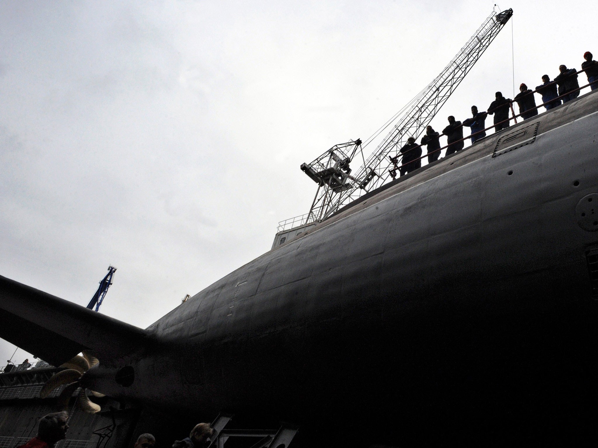 Workers attend the launching ceremony of the Russian diesel-electric attack submarine Stary Oskol on Admiralty Shipyard in Saint Petersburg on August 28, 2014