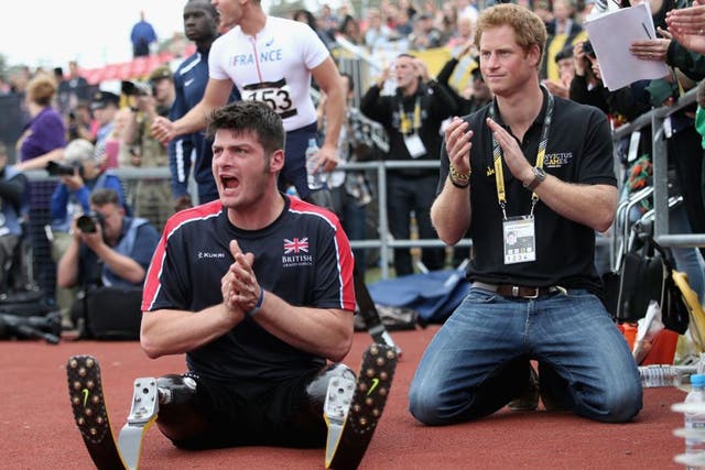 Dave Henson pictured with Prince Harry cheering on the British team at the 2014 Invictus Games
