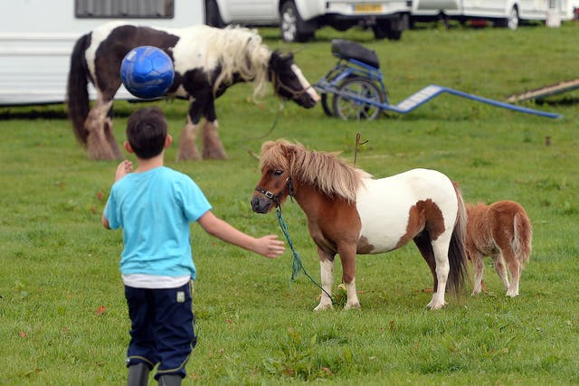 A child plays with a ball during the Appleby Horse Fair. The event is one of the key gathering points for the Romany, gypsy and traveling community