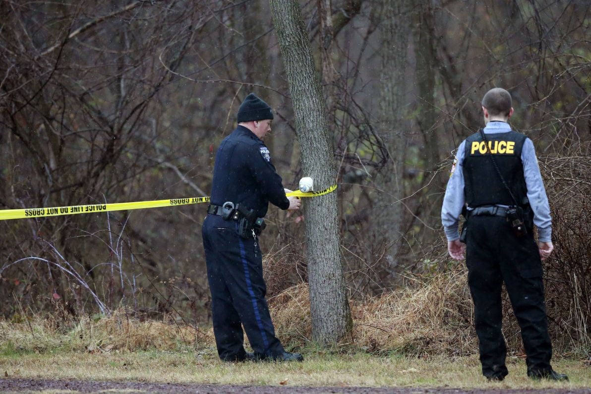 Police cordon off a wooded area during the search for suspect Bradley William Stone