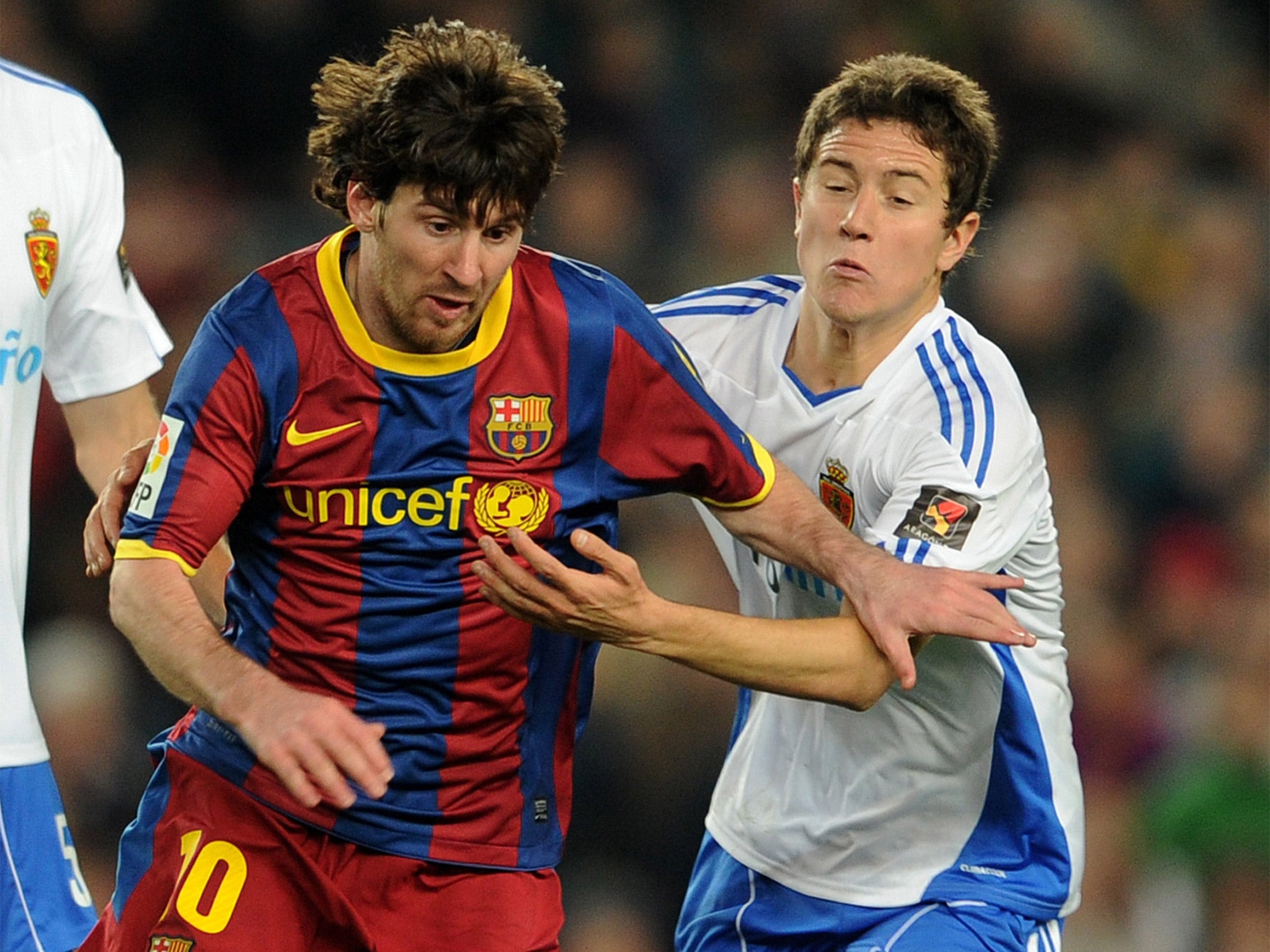 Ander Hererra (right) takes on Lionel Messi during his time at Real Zaragoza