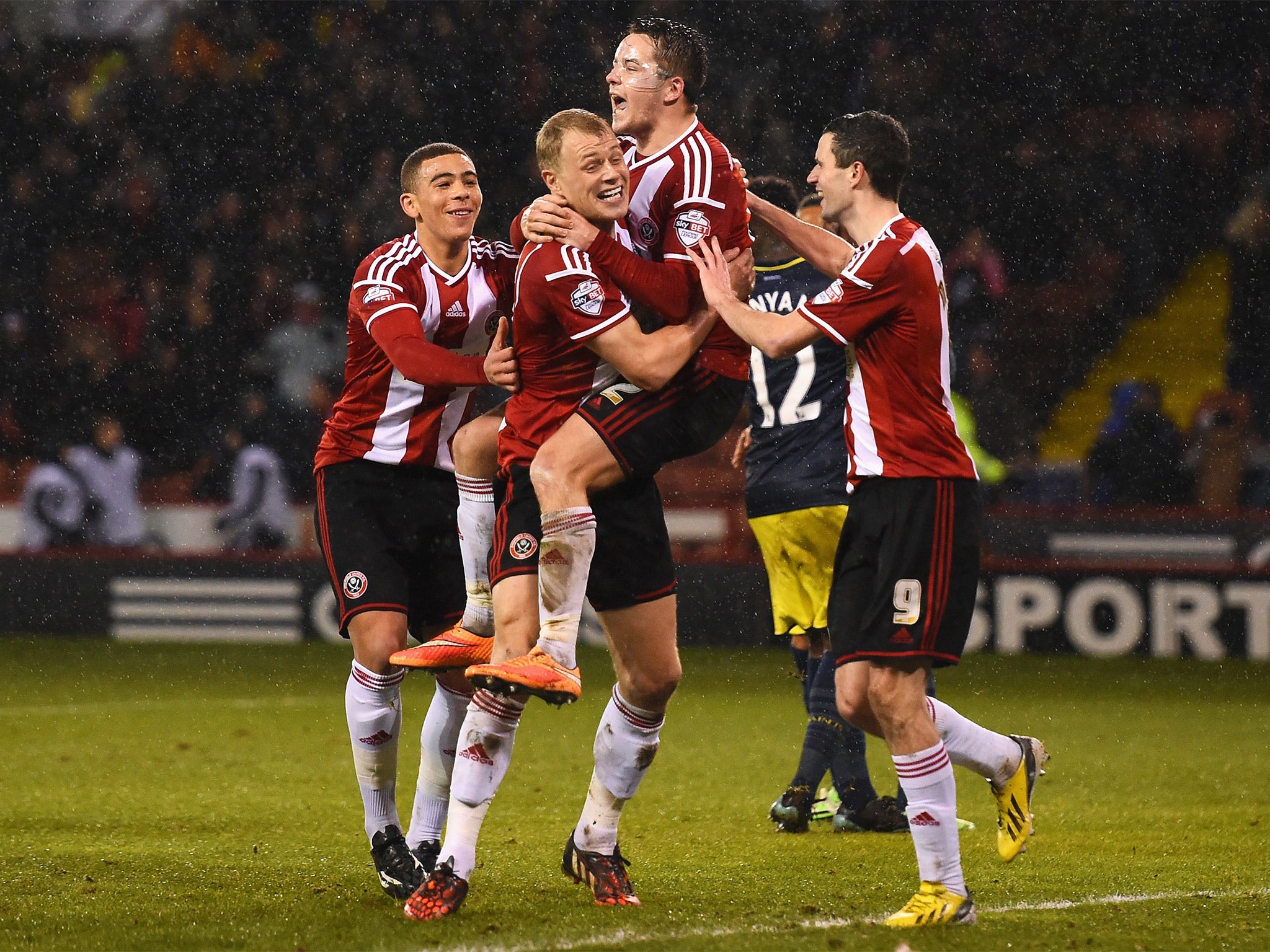 Match-winner Marc McNulty (in mask) celebrates with his Sheffield United team-mates