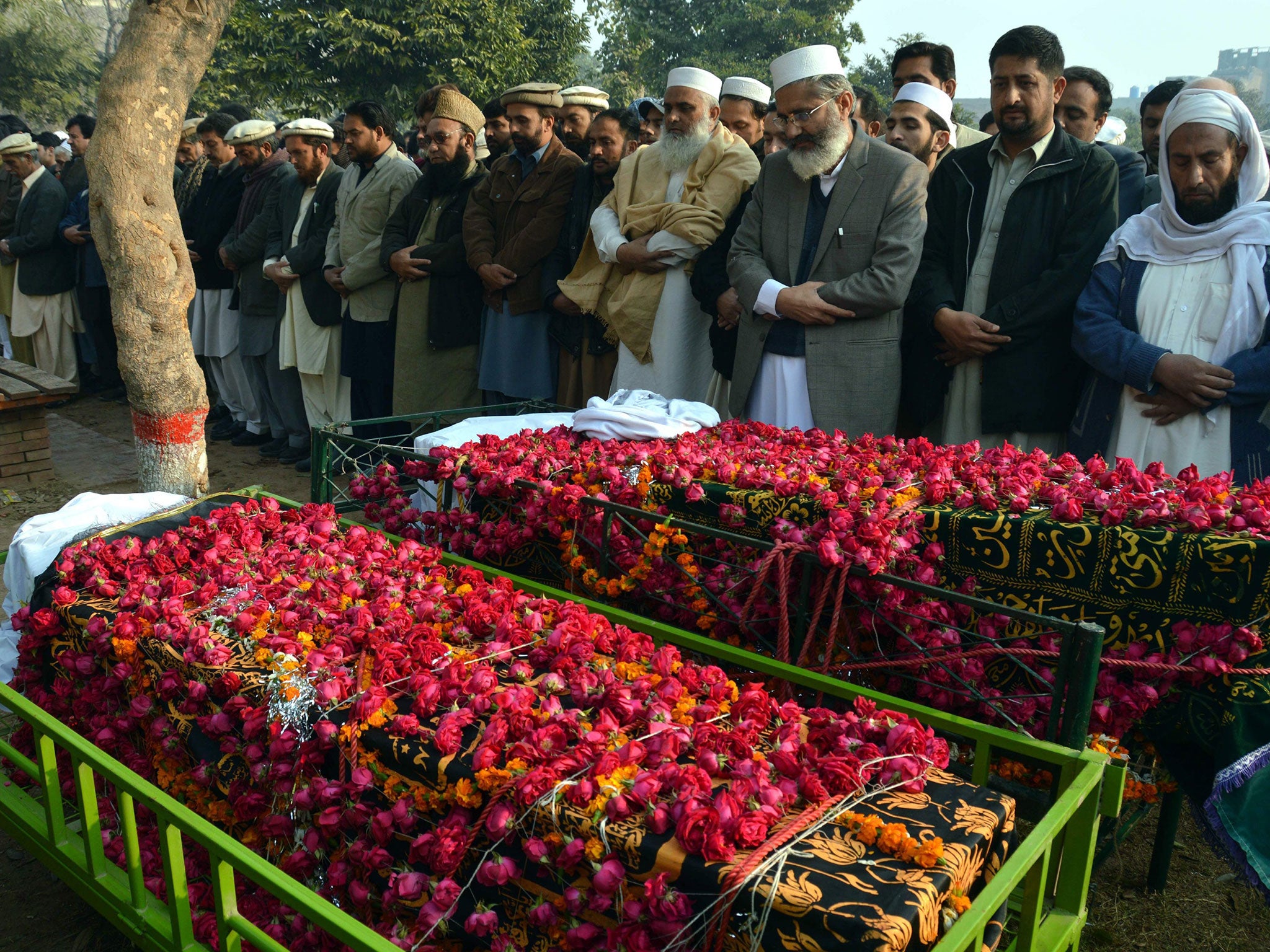 Sirajul Haq, head of the Islamic political party Jamat-e-Islami, leads the funeral prayers of two school boys who were killed by Taliban militants at a school run by the Army, in Peshawar, Pakistan