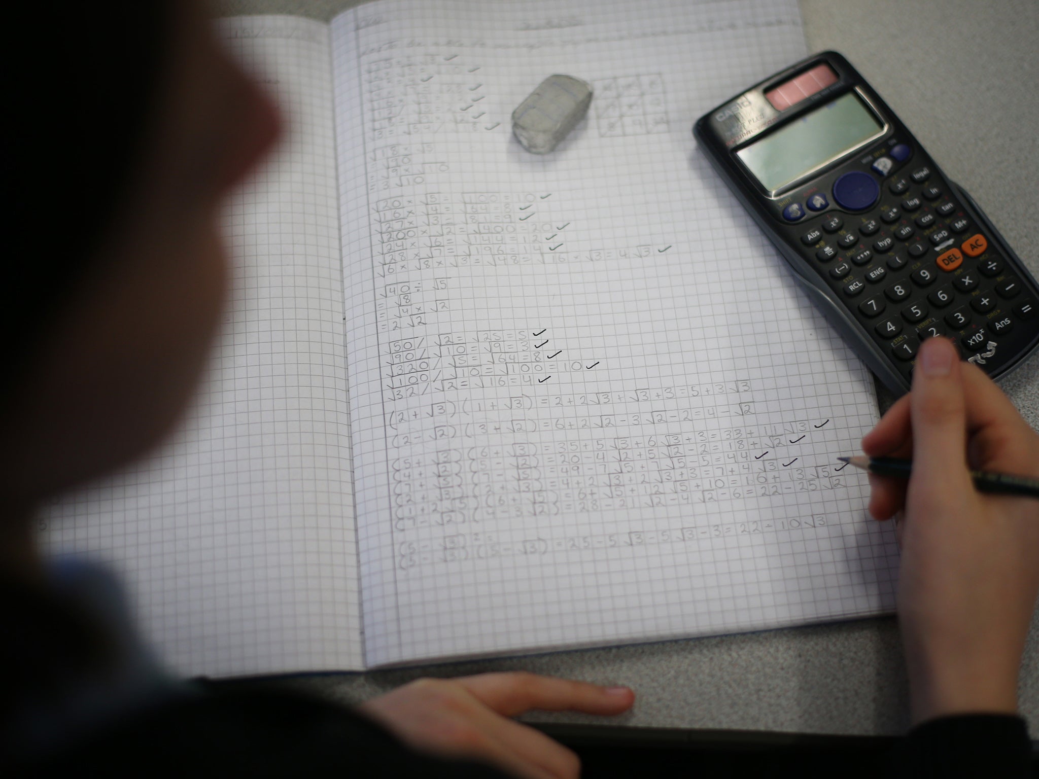 A student takes part in a maths lesson at a secondary school in London.