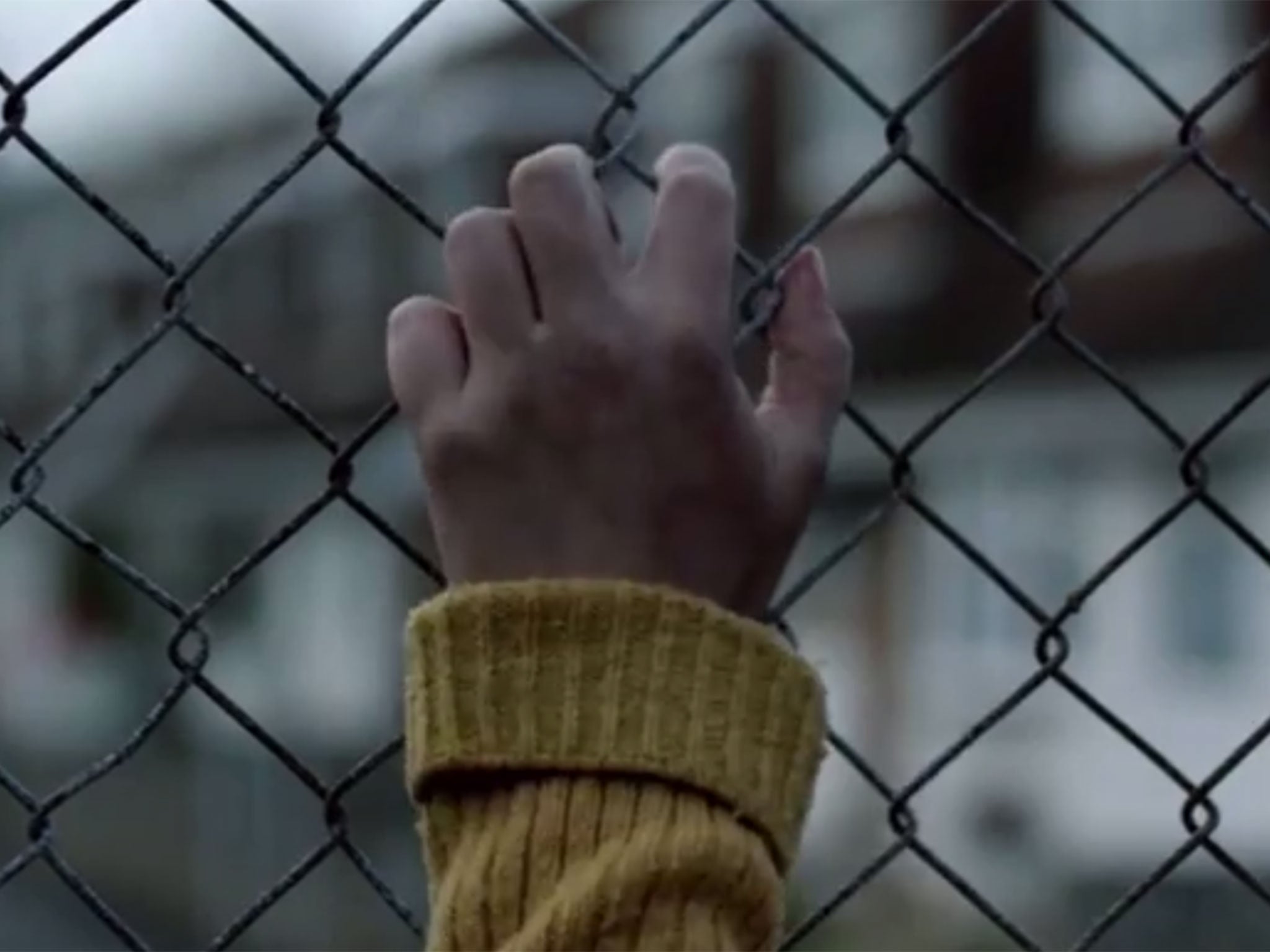 A girl clutches at a fence in The Missing series two trailer