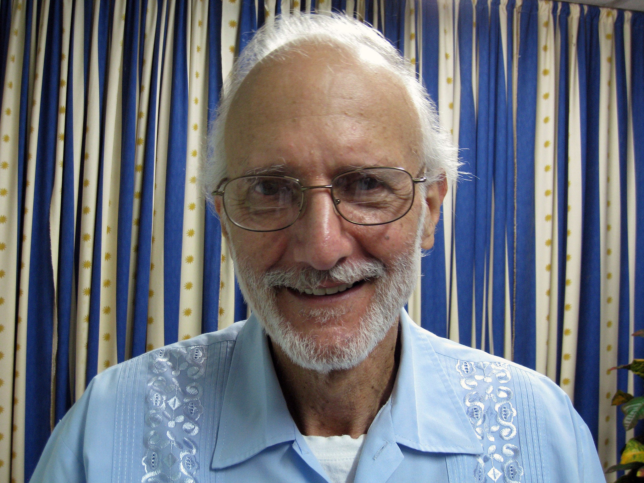 Alan Gross poses for a photo during a visit by Rabbi Elie Abadie and U.S. lawyer James L. Berenthal at Finlay military hospital as he serves a prison sentence in Havana, Cuba