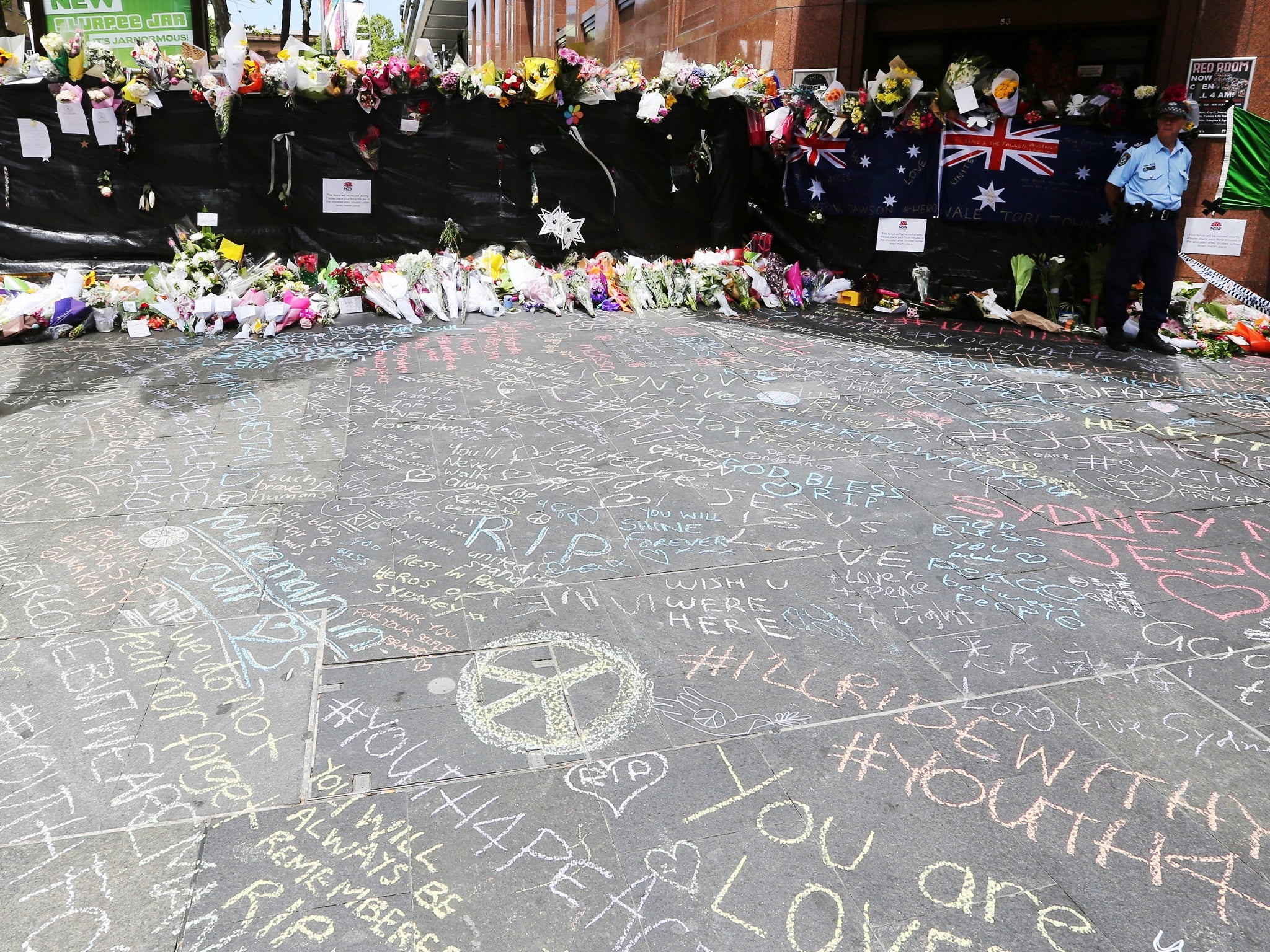Chalk messages left on Martin Place after the siege in a café on Tuesday where two people were shot dead by a gunman