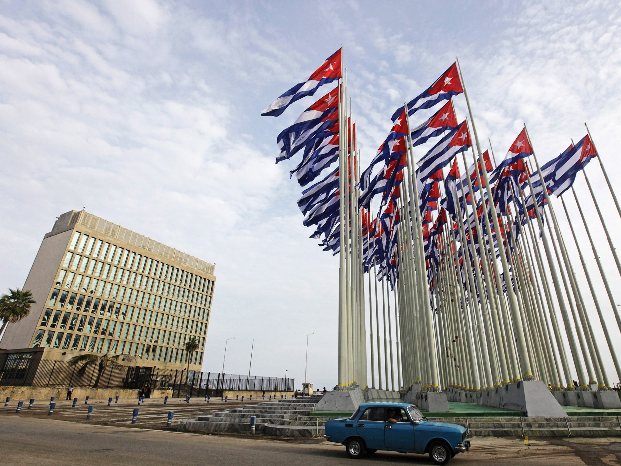 A car drives past the building of the US Interests Section, in Havana