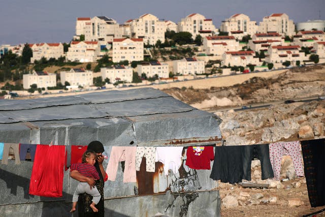 Bedouin people overlook Israeli settlements in the West Bank, which have multiplied over 40 years
