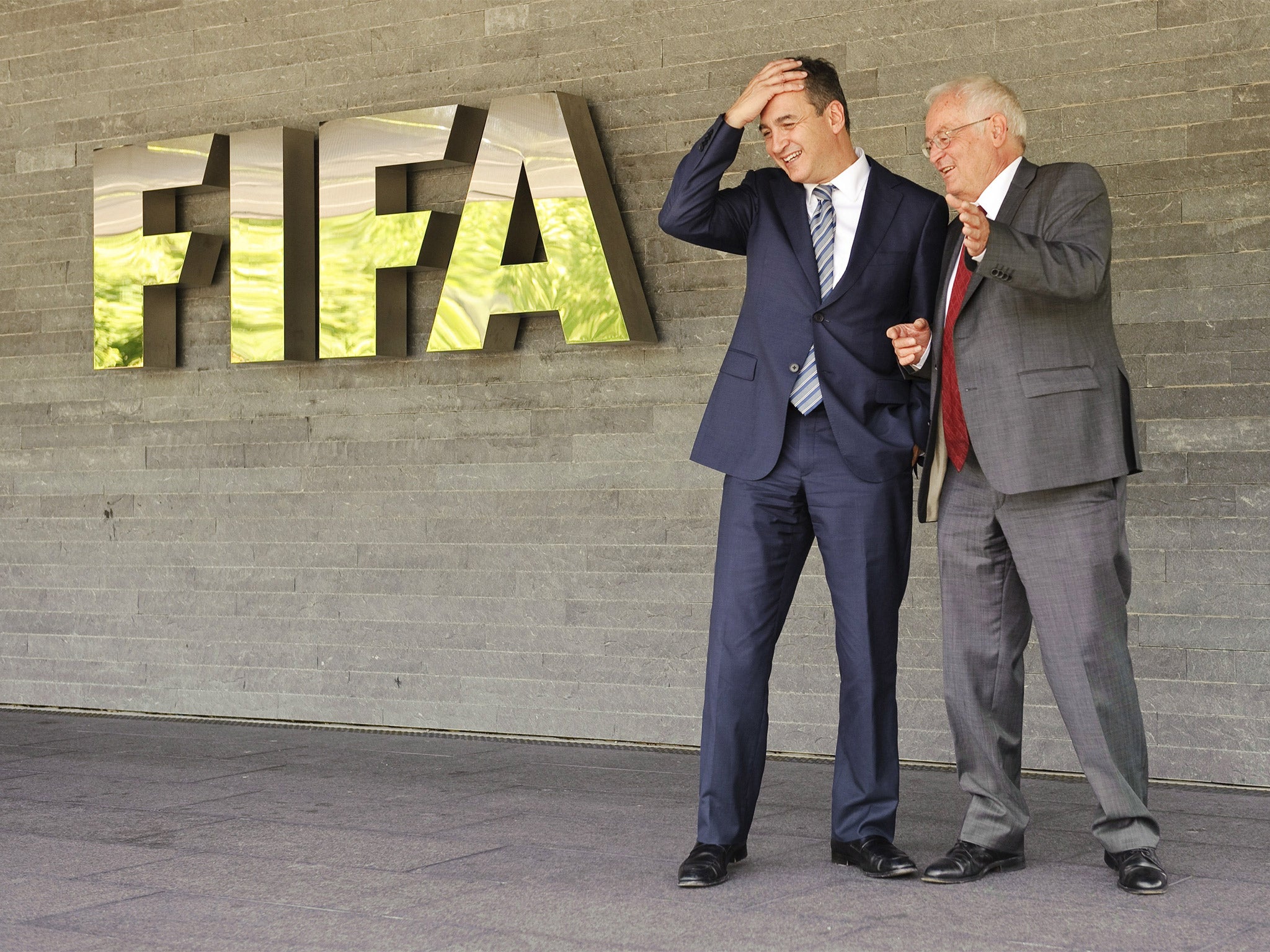 Michael Garcia (left), the former Fifa investigator, and Hans-Joachim Eckert (right), who summarised his report, outside Fifa headquarters in 2012