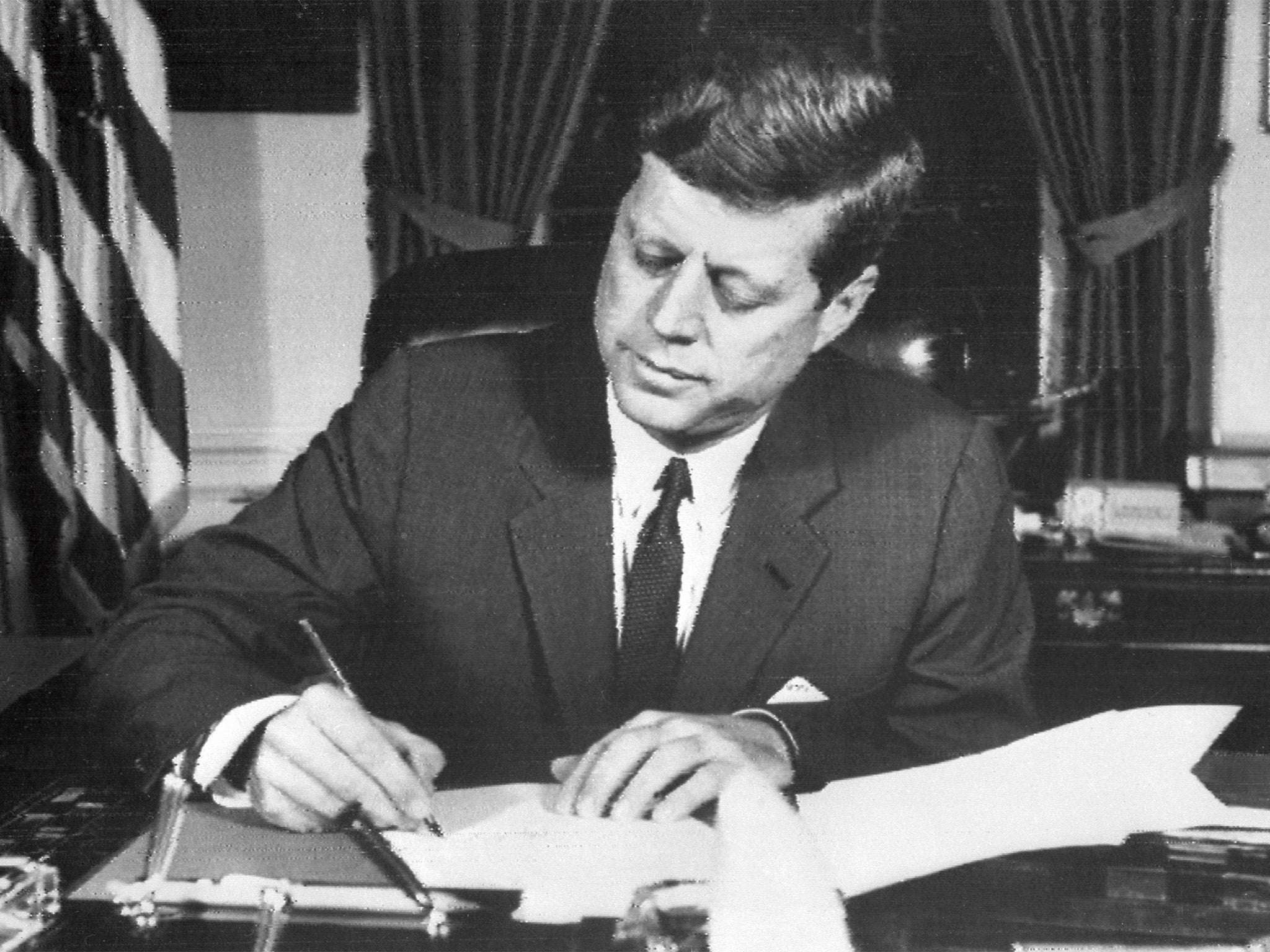 US President John F Kennedy signs off a naval blockade in 1962 (Getty)