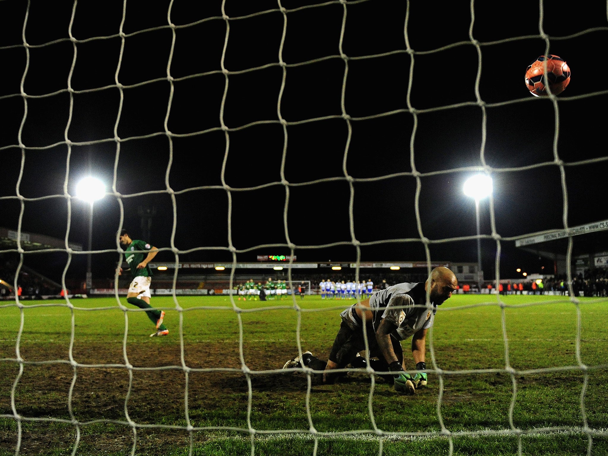 Worcester goalkeeper Nathan Vaughan is beaten by Miguel Llera of Scunthorpe for winning spot-kick