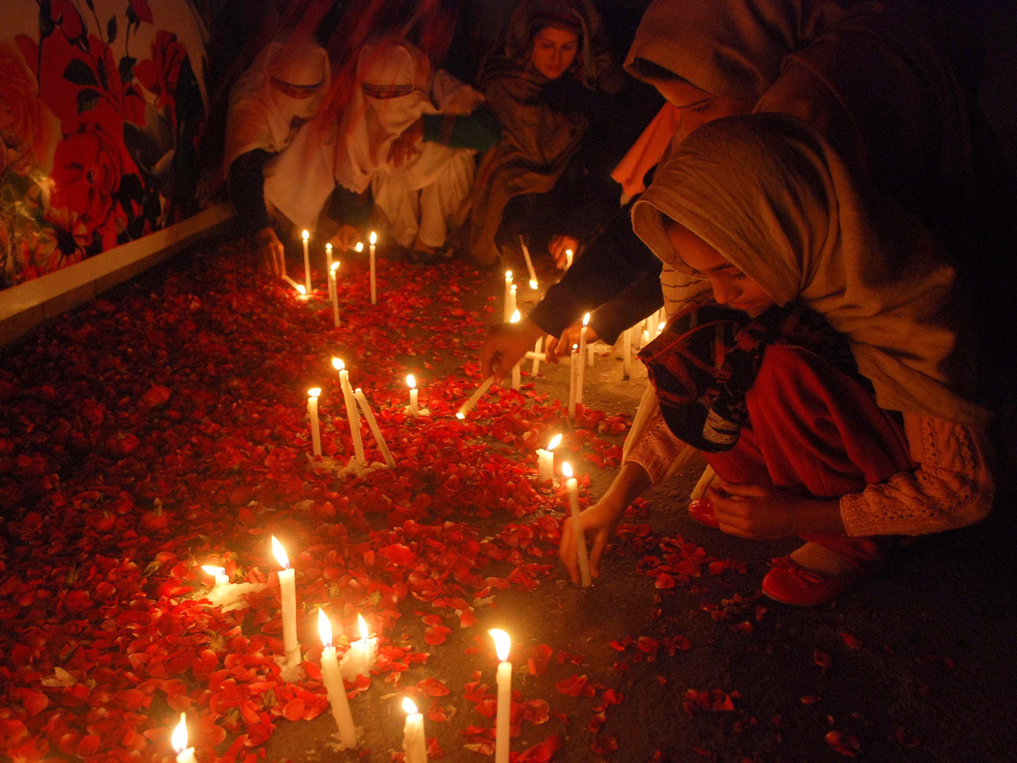 People light candles in memory of victims